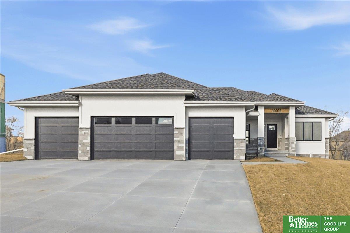 Showcase Homes beautiful split bedroom ranch plan w/ 4 car garage. On a walk out lot backing to trees!  Generous upgrades and modern finishes throughout. Beautiful great room w/ linear fireplace, shiplap wall & built in cabinets that make a big statement. Gorgeous kitchen w/ custom cabinets and shelving, 36" gas cooktop, soft close drawers & doors, wood cabinet hood, large island w/ quartz countertops & spacious walk-in pantry. Private primary suite tucked away from the main part of the home and other bedrooms. Primary has large closet that connects to laundry room. Awesome finished basement w/ large rec area as well as 2nd fireplace and wet bar with tabletop island, 2 bedrooms w/ walk in closets, 3/4 bath, and large storage room. The house is a must see! Will be complete 6/3/2026.  Photos of same floorplan but different home. List agent has equity.