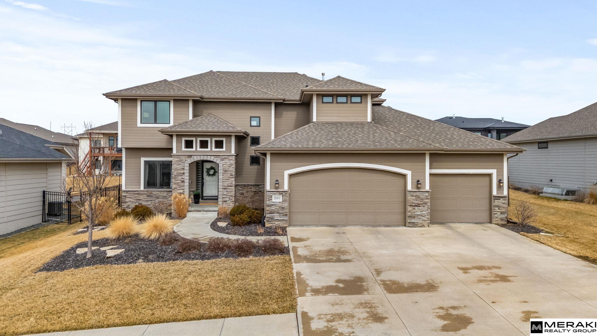 **OPEN HOUSE SUN 3/8 1-3pm!!** WOW! You'll love this open concept 2 story, 4 bed, 3 bath, 3 car with over 2,300 sq ft of updated finishes, modern style and expert design in sought after Blondo Ridges. Enter the 2 story vaulted foyer where you will be greeted by wide open living space and an abundance of natural light shining through the large windows. Make you way to the living area with cozy stone fireplace and into the spacious kitchen with SS appliances, Birch cabinets, Granite counters, pantry, island and dining area. With 4 bedrooms and laundry on the upper level, you'll find size and comfort the whole family can enjoy. The primary suite offers tray ceiling, oversized walk-in closet, double vanities and lare walk-in shower. Spend time in your large, fully fenced backyard with covered patio and sprinkler system - great space for entertaining. Within walking distance to Blondo Ridges Park and in Elkhorn School District. This West Omaha gem has everything you've been waiting for!