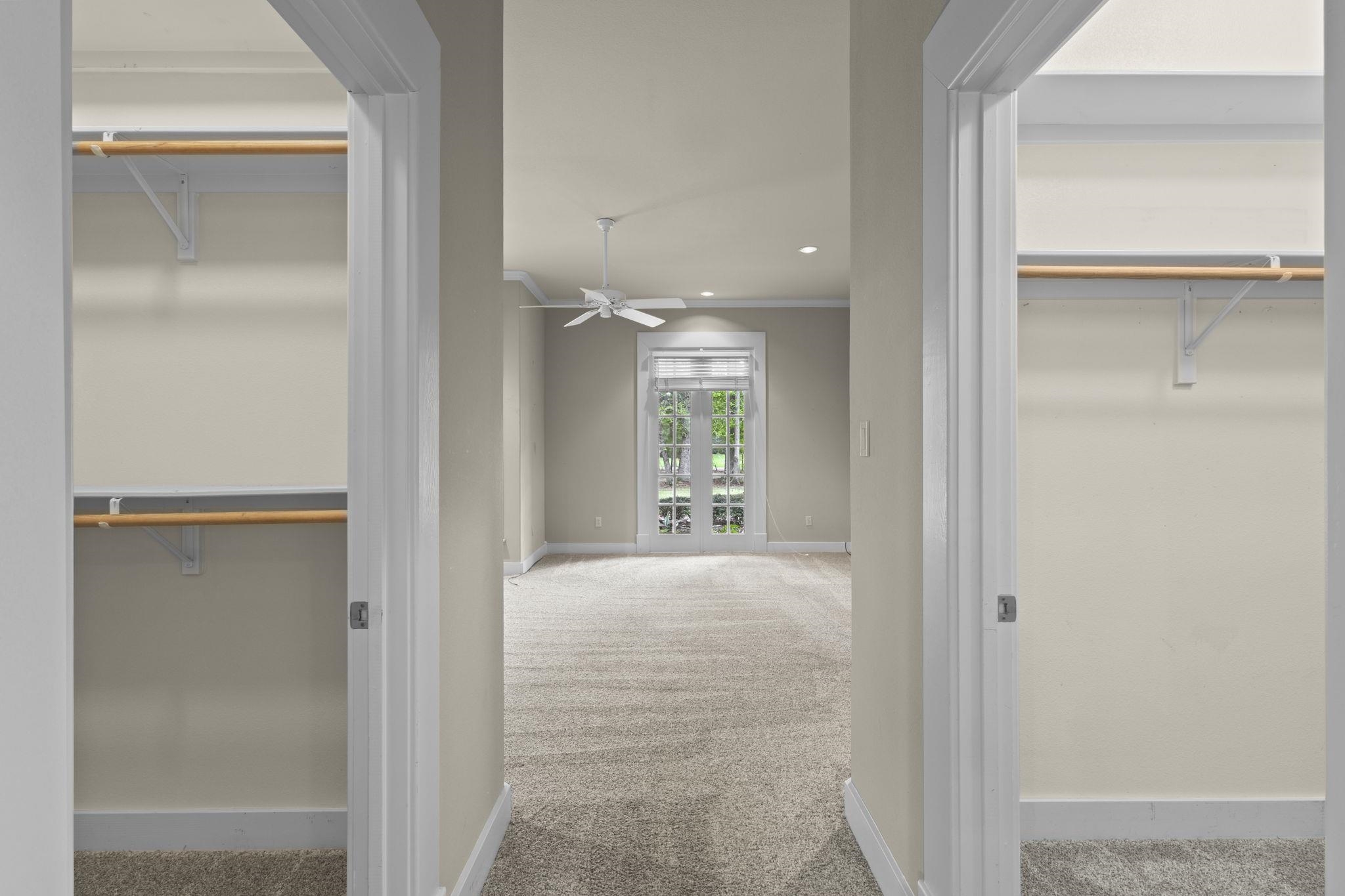 Walk-in closet with built-in organizers, hanging rods, and shelving on both sides