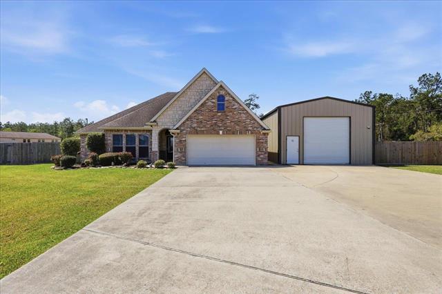 Full front exterior with driveway and garage