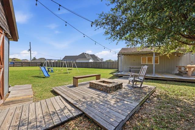 Back deck with fire pit and string lights