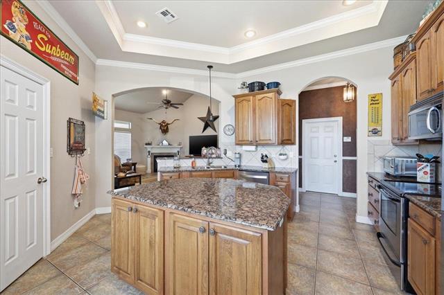 Kitchen with granite island and stainless appliances
