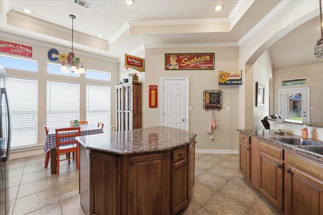 Kitchen from sink side with breakfast nook visible