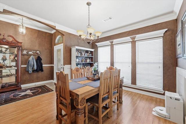 Dining area with wooden table and chandelier