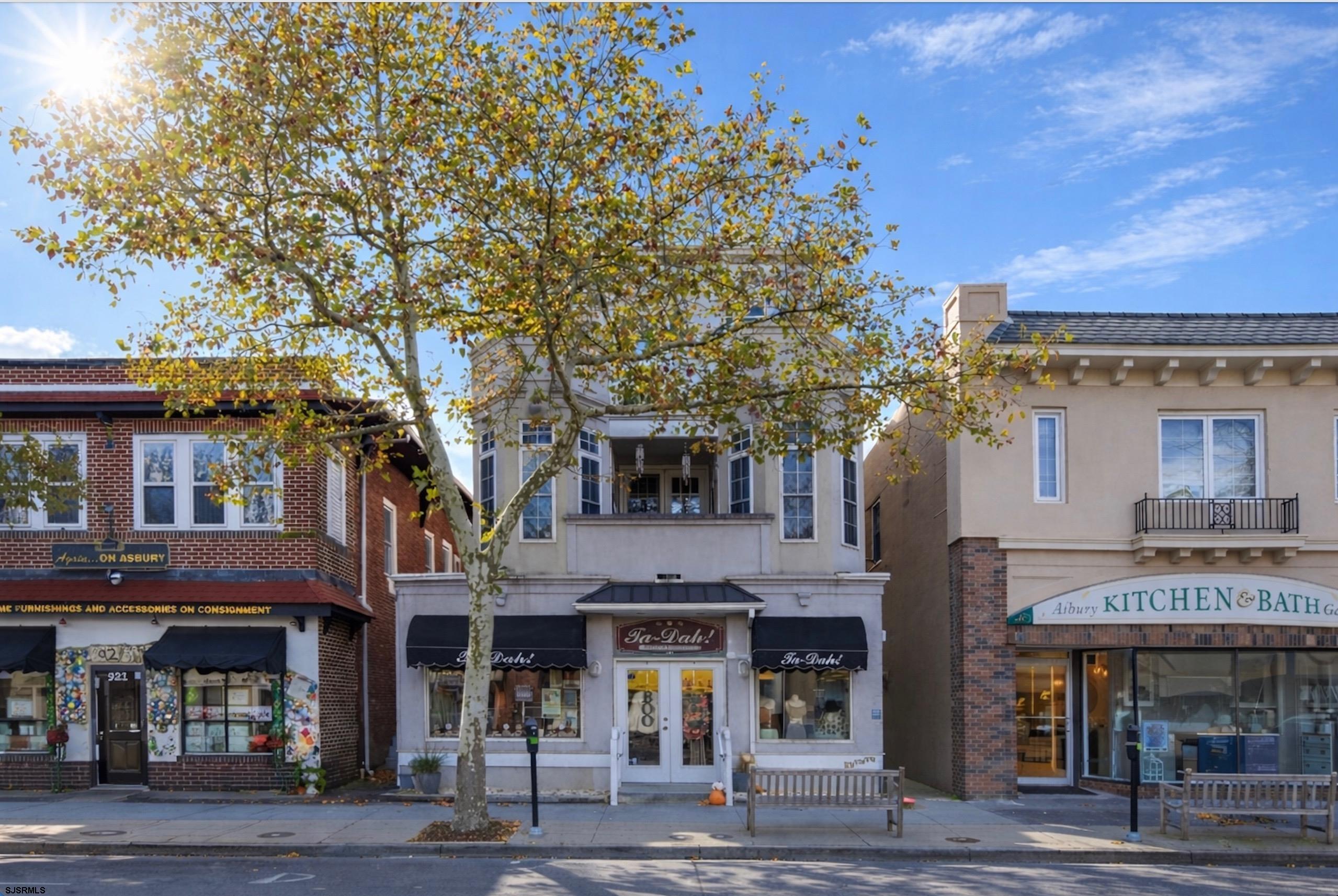 Welcome to downtown Ocean City an extra large, beautifully designed 4 bedroom, 2 bath second floor condo offering 1,608 square feet of sophisticated living space - PLUS a private one car garage and additional off street parking. A rare opportunity to own exceptional space, value, and walkability on the island. Centrally located in the heart of downtown Asbury Ave. The interior is super clean, move in ready, and loaded with upgrades including hardwood flooring, a gourmet kitchen with granite countertops, stainless steel appliances, and spacious living room with gas fireplace. A thoughtful layout includes 4 sizable bedrooms, highlighted by a king size primary suite with walk in closet. 2 bonus sunrooms/ home offices open off a stylish metropolitan outdoor patio. Additional features include a dedicated laundry room, abundant closet space, a desirable enclosed stairwell, gas heat and central air, and private garage. Tastefully decorated and filled with plenty of natural sunlight, this home offers sweeping views of charming downtown Ocean City - with NO HOA fees. Given the size, layout, and location this property offers strong seasonal rental potential.