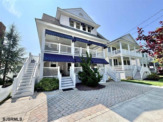 The Ultimate Beach Getaway. Located just a short distance to the beach, boardwalk, and downtown shopping district, this move-in-ready 3 bedroom, 2 bath property is perfectly positioned just one and a half blocks from the beach, offering exceptional walkability while being set just off the main strip. A charming second-floor unit with beautiful hardwood floors, a spacious dining area off the kitchen, and a covered front porch is just the beginning of this great space.  An updated kitchen with open shelving, granite countertops, and stainless steel appliances flows seamlessly into the dining area, perfect for a cozy dinner or family gathering. The two-story setup offers privacy for the three bedrooms, each adorned with transom windows above the doorway, closet space, and great natural light. Front and rear porches provide great outdoor space to enjoy, along with a private enclosed outdoor shower and off-street parking.   Park the car and leave it behind. Boyar’s Market, Johnny B Good Ice Cream, and Johnson’s Popcorn are just steps away, with the boardwalk nearby for beach days, bike rides, and evening strolls.