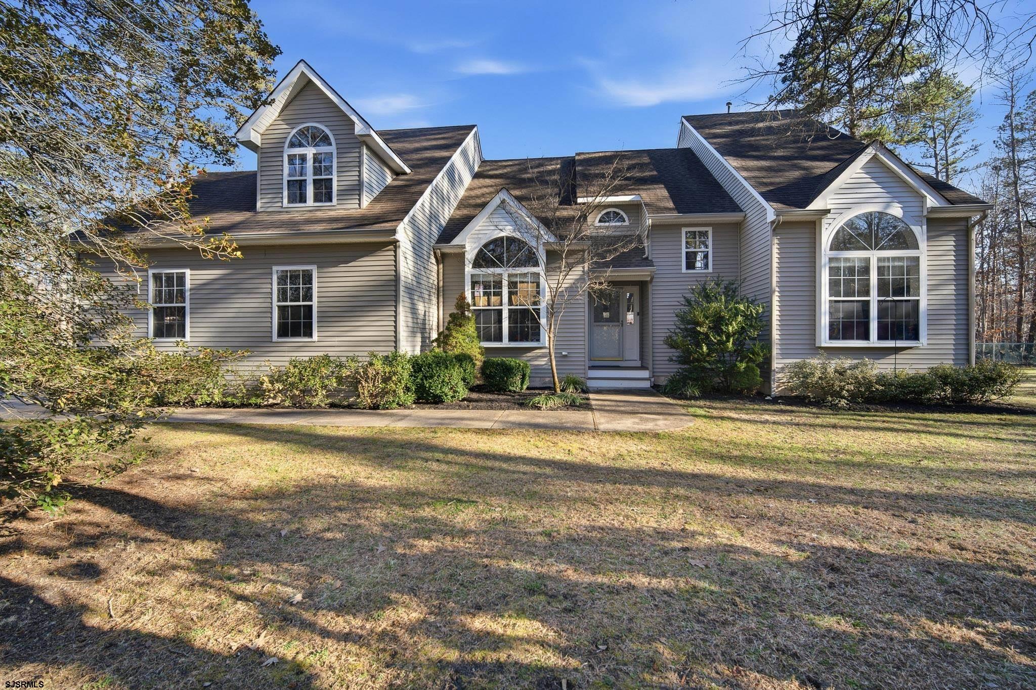 Nestled in the serene surroundings of Egg Harbor Township, this exquisite contemporary residence offers a perfect blend of luxury and comfort. Spanning over 3,500 square feet, this home is designed for those who appreciate high-end living and the tranquility of nature, all while being just moments away from modern conveniences. As you step inside, you are greeted by an inviting atmosphere that seamlessly combines elegance with warmth. The spacious layout features 4 generously sized bedrooms, 2 of which offer ensuite baths. Cedar closets in the bedroom are part of the thoughtful design as well in the Primary bedroom which features a fireplace (sold in as is condition), a large sitting area and floor to ceiling windows that offer amazing views of your colorful, sun filled yard and pool view!  The heart of the home is undoubtedly the stunning living area, where a  beautifully appointed fireplace creates a cozy ambiance, perfect for gatherings or quiet evenings at home. The kitchen is equipped with top-of-the-line appliances including a gas oven/range, refrigerator, dishwasher, and microwave. The thoughtful design ensures that meal preparation is a delight, while the adjacent dining area offers a picturesque view of the lush, wooded surroundings, enhancing every dining experience. Step outside to discover your own personal oasis. The expansive 5.22-acre lot features a luxurious in-ground saltwater pool, complete with heating and a secure fenced area, making it an ideal retreat for relaxation and entertainment. Imagine summer days spent lounging by the pool, surrounded by the beauty of nature, or hosting unforgettable gatherings under the stars on the large deck. Also included opposite the pool yard you'll find a kid's paradise with the custom built treehouse complete with professional grade rope bridge and zipline! There is also a separate fenced in yard for your four legged friends!! The property also boasts an attached side-entry garage with additional storage space, ensuring that all your needs are met. With a main floor laundry room, convenience is at your fingertips, allowing you to enjoy the finer things in life without the hassle. The tranquil views of trees and woods provide a serene backdrop, creating a peaceful environment that feels like a private sanctuary. This home is not just a place to live; it's a lifestyle choice that offers the perfect balance of luxury, comfort, and nature. Experience the exclusive lifestyle that this remarkable property has to offer, where every detail has been thoughtfully curated to provide a sense of home and comfort. Don't miss the opportunity to make this stunning residence your own. Most of the mechanicals are newer. AC units, Roof, Septic, Tankless water heater, pool heater and filter are all updated. Also includes a 6 zone sprinkler system. Sellers Disclosure is available. Showings will begin March 7 and 8th at our Open Houses from 11 AM to 1 PM.