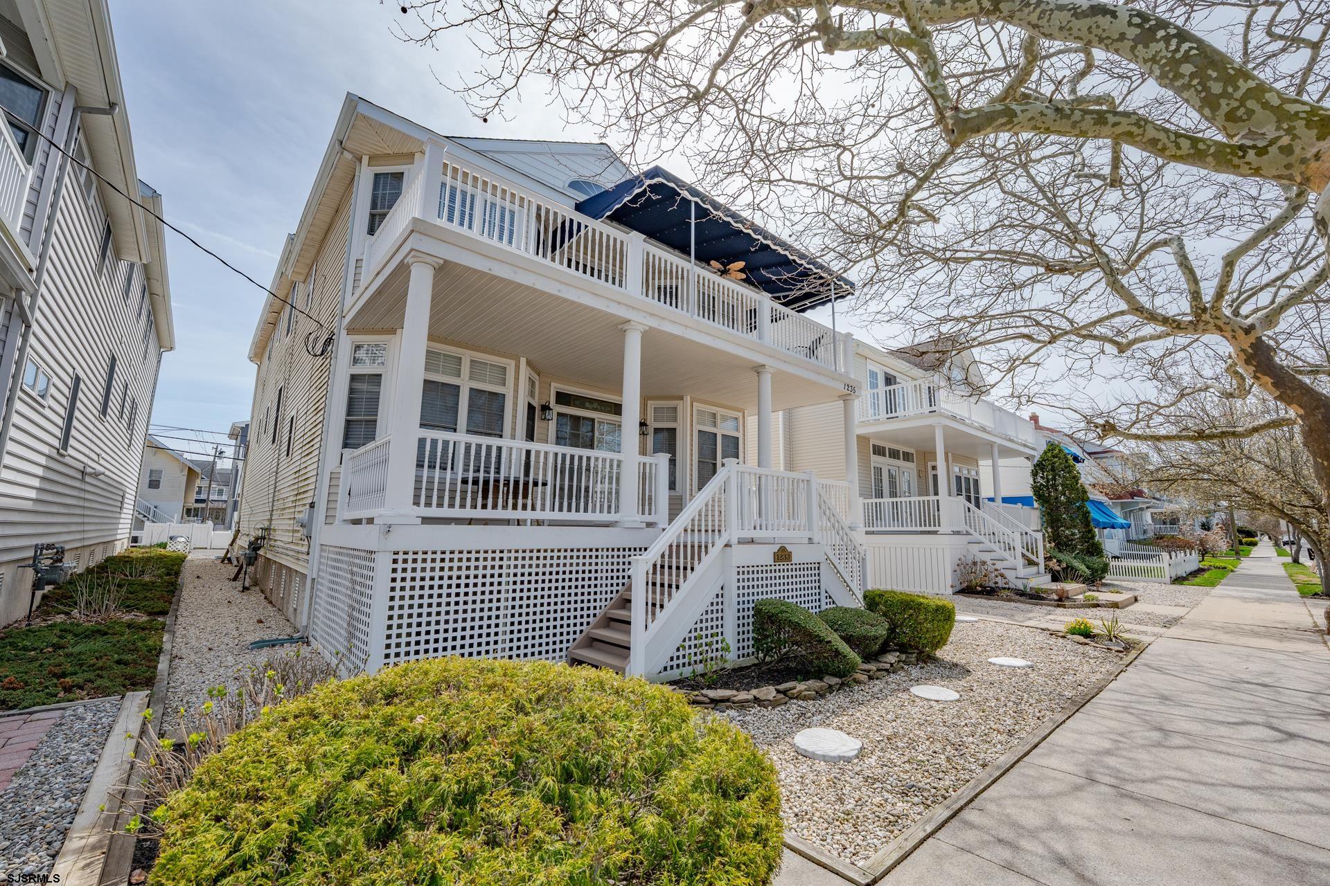 Introducing 1235 Central Ave, a well-appointed second-floor residence in Ocean City, NJ offering approximately 1,600 square feet of living space. This 4-bedroom, 2.5-bath home is thoughtfully designed to balance comfort, functionality, and coastal convenience. The interior features vaulted cathedral ceilings with skylights, creating a bright and open atmosphere throughout the main living area. The layout is designed to support both everyday living and entertaining, with seamless flow between the living, dining, and kitchen spaces. The property includes an oversized front porch enhanced by a partially covered custom awning and ceiling fan, providing a versatile outdoor living area. Additional highlights include private storage, a cabana shower ideal for post-beach use, and a garage for added utility. Each bedroom offers generous proportions, while the primary suite includes its own private bath. The home’s design maximizes both space and natural light, contributing to a comfortable and inviting environment. Situated on a tree-lined street, this location offers close proximity to the beach, boardwalk, and downtown Ocean City. This property presents an opportunity to enjoy a well-located home with desirable features in a sought-after coastal setting.
