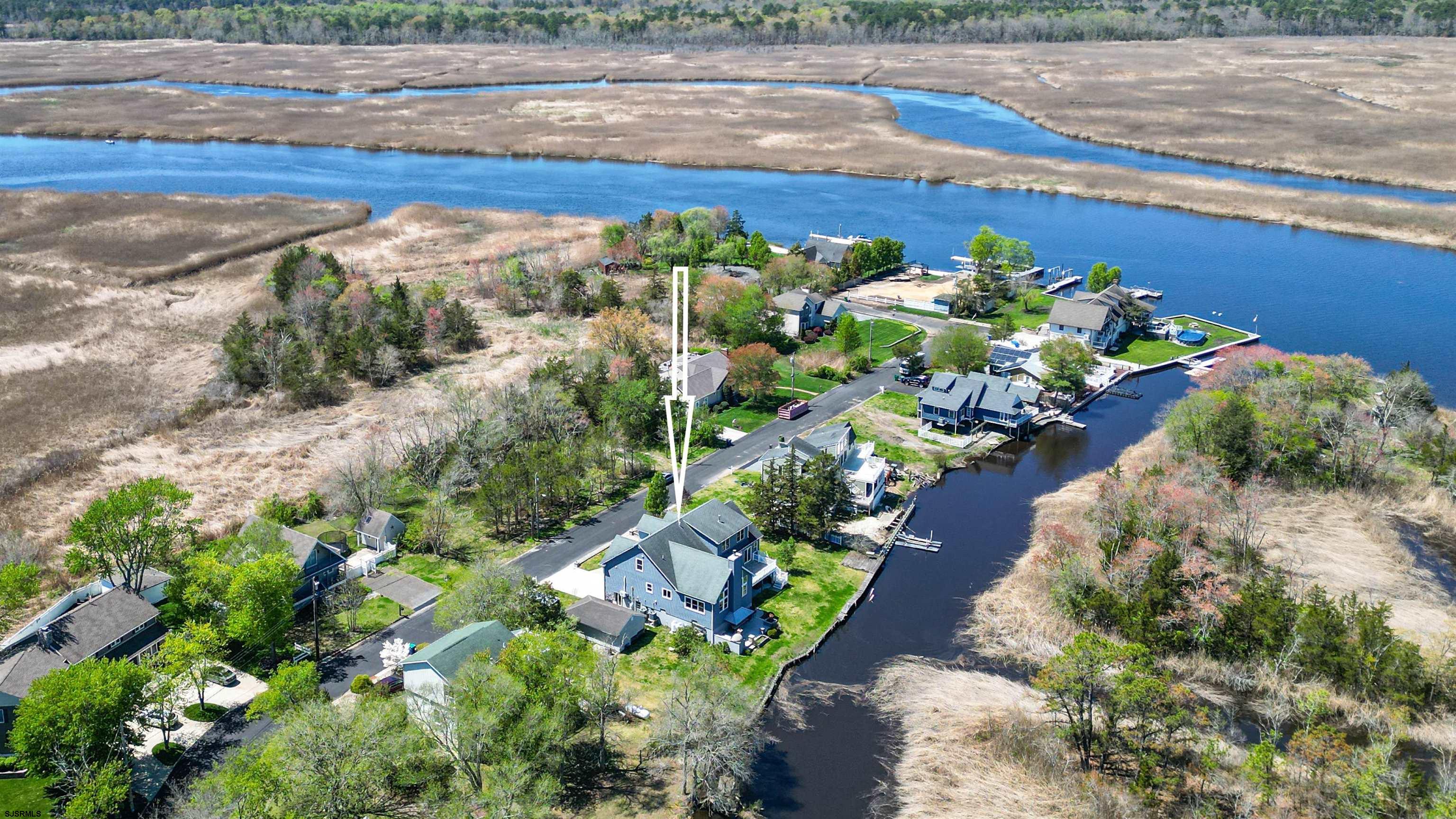 Welcome to one of the most quiet and secluded portions of the Greater Egg Harbor River, tucked away on the desirable Harbor Drive in Egg Harbor Township. Rebuilt and custom designed in 2015, this stunning waterfront home offers the perfect blend of luxury, comfort, and true South Jersey river living. Featuring 4 bedrooms, 3 full bathrooms, and 1 half bath, this home was thoughtfully designed to capture breathtaking water views from nearly every room. Whether you’re relaxing inside or entertaining outside, the setting is nothing short of incredible. The main level offers a rare layout with two spacious bedroom suites, each with walk-in closets and private bathrooms, creating the feel of dual primary suites on opposite sides of the home. The open living space is filled with natural light and showcases the river as your everyday backdrop. Upstairs, you’ll find a loft overlooking the main living area, along with two additional bedrooms and a full bathroom, perfect for guests or additional living space. Step outside and experience what truly sets this home apart. Enjoy peaceful mornings or sunset evenings on the upper rear deck, or entertain effortlessly in your outdoor kitchen complete with a pizza oven, all overlooking the water. This is the lifestyle people dream about. The ground level offers endless storage with a full basement, an attached two-car garage for everyday convenience, and an additional shed for all your outdoor and boating needs. A gas meter is already installed, providing the option for future conversion. If you’ve been waiting for a one-of-a-kind waterfront property in a truly special location, this is your opportunity. Come experience river living at its finest.