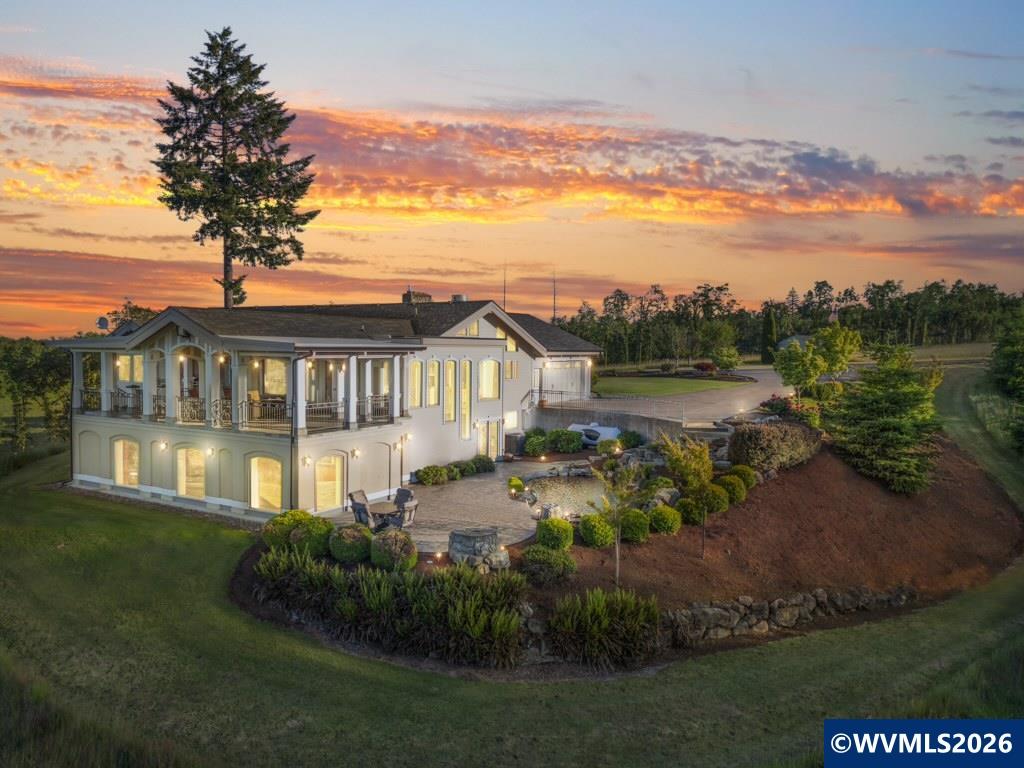 Situated among five acres of open pasture and green spaces, with sweeping Cascade views, this 4BD/5BA estate delivers luxury at every turn. Soaring vaulted ceilings, rich hardwood/stone floors, and high-end appliances set the tone, while the chef's kitchen, dedicated wine room, private home gym, and movie theater make entertaining effortless. The primary suite is a true retreat. A large shop and additional utility shop add exceptional versatility. A rare offering for the buyer who wants it all.