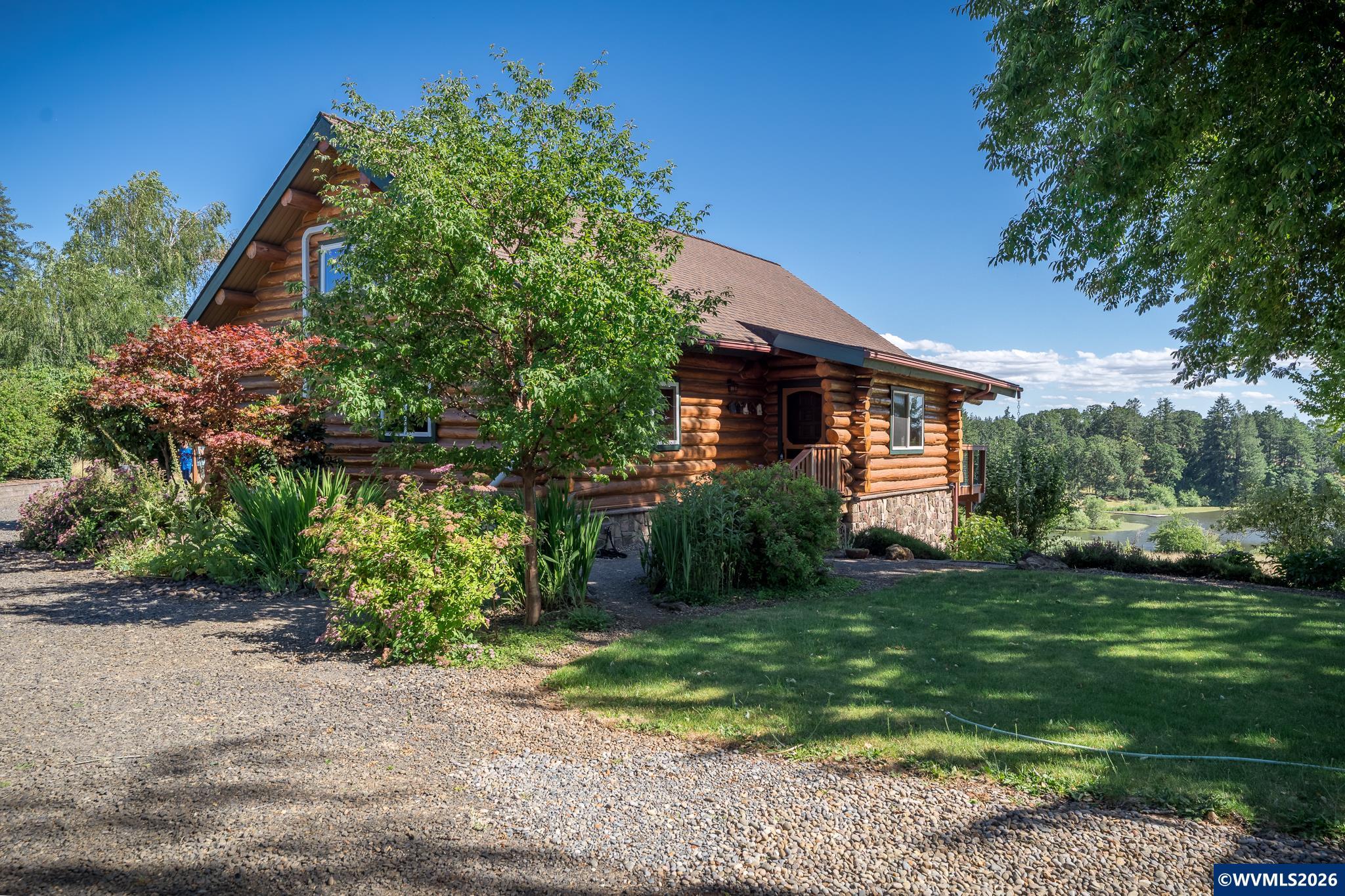 Set on 4.9 tranquil acres in Spring Lake Estates, this meticulously maintained home boasts vaulted ceilings, huge windows & extensive decking for expansive views of the private lake, Coastal range & Ankeny Wildlife Refuge. Primary BR/updated bath on the main, liv rm w/fp, kitchen w/walk-in pantry. Skylit loft upstairs for office, great room. Lower level w/3BR (2 w/views), full bath, laundry, work room & sep entrance for dual living. Garden beds, shed, central air, RV pkg. Community hiking, riding trails. Set on nearly 5 private, peaceful and tranquil acres in Spring Lake Estates, this meticulously maintained log cabin home blends timeless craftsmanship and Pacific Northwest natural beauty. The soaring vaulted ceilings, wall of windows and extensive decking focus on views of the private lake, coastal range and Ankeny Wildlife Refuge. The primary bedroom and updated bath are located on the main level along w/the kitchen with walk-in pantry, living room with fireplace and dining room. A skylit loft upstairs can be used as a home office, studio, or great room. The lower level has potential for dual living with three bedrooms, two with views, a full bath, laundry room, dedicated workroom and separate entrances.Outside are raised beds, extensive fire safe landscaping, and garden shed for gardening tools. Spring Lake Estates offers private hiking and riding trails along with boating opportunities during the summer.
