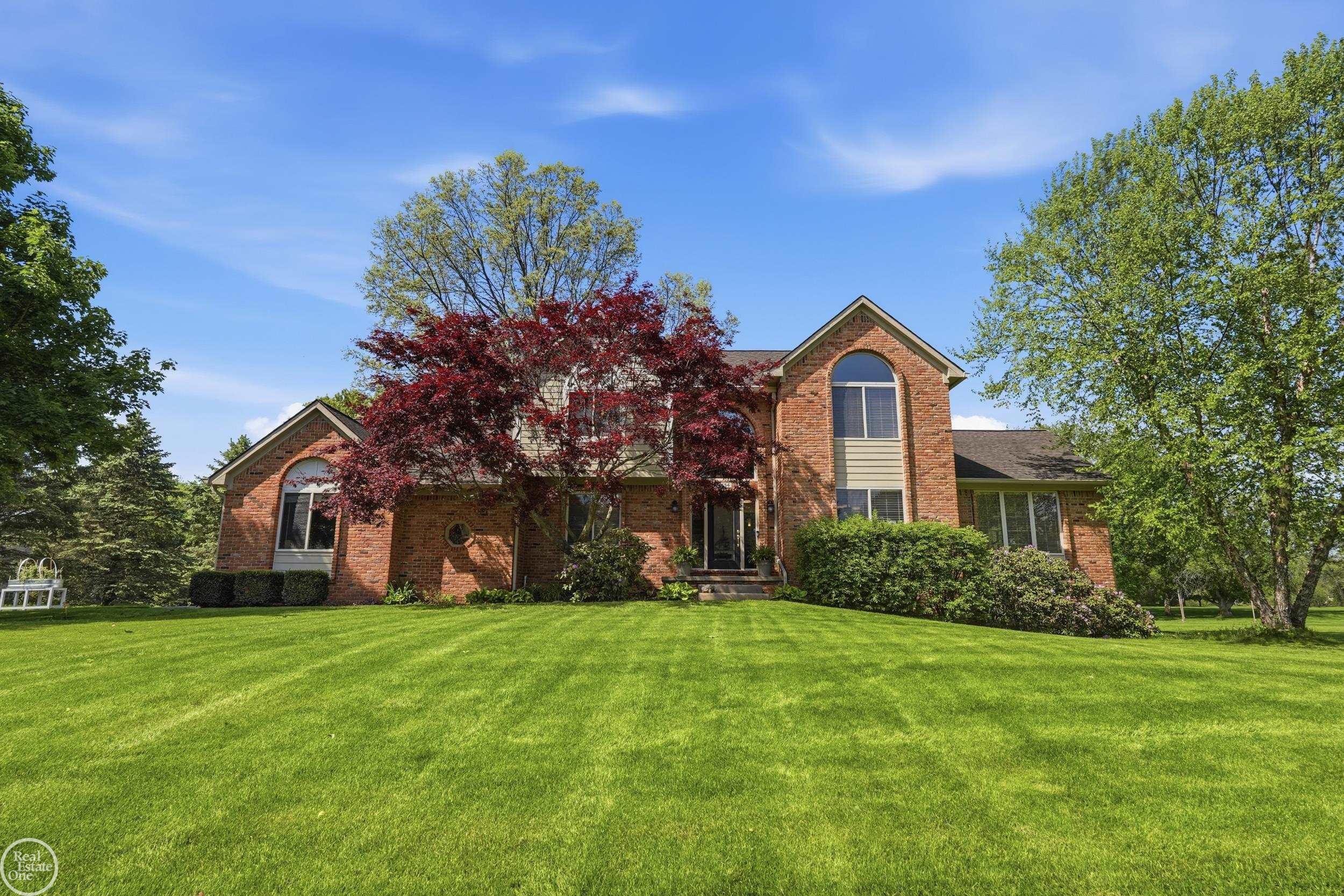 Don't Miss This Opportunity! Lovely, custom brick colonial offers perfect blend of comfort and functional living on beautiful, park-like 1.45-acre setting. Freshly painted, move-in ready, packed with quality finishes. Abundance of windows flood home with natural light. Spacious kitchen is beautifully appointed with SSA, wine refrigerator, osmosis filtration system, and easy access to deck for seamless indoor/outdoor living. Built-in sound system for enhanced entertaining and everyday enjoyment. Rarely found...all upper level bedrooms are private ensuites with their own full bathrooms and deep closets. Fully finished daylight basement lives like an added level of the home thanks to garden windows and abundant natural light. It includes a 4th BR with large closet, full bathroom, and second built-in kitchen featuring granite countertops. Custom fieldstone bar with solid cherry wood top creates an incredible gathering space. Extraordinary opportunity to own a truly turnkey home in one of White Lake's most desirable neighborhoods.