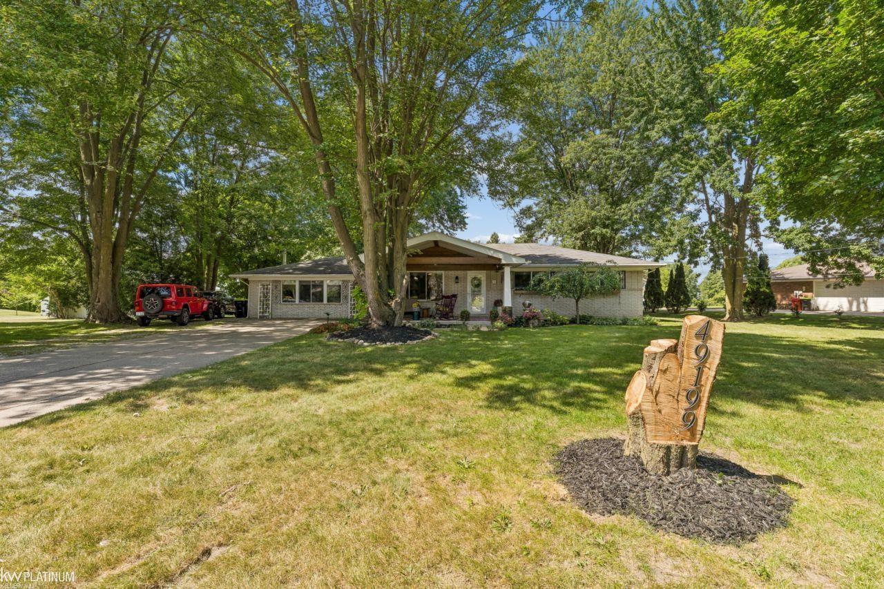 OPEN HOUSE Sunday, 8/30/26 from 12-3pm.Welcome to 49199 Fairchild Rd., where outdoor oasis meets move-in ready! A home like this on a 2.35 acre lot doesn't come around Macomb Twp often (or ever)-craftsman style front porch, stamped concrete back patio with an outdoor kitchen and gorgeous fireplace, fenced in yard for the dogs, a huge 30'x40' pole barn with electricity and 10' tall by 16' wide garage door, 2 additional sheds, the list doesn't end here. Inside you will find an updated home with granite countertops, double ovens(!!), a living room with heated flooring and a wood burning stove, beautiful bathrooms, a finished basement, but wait there's more! New furnace and air condition unit replaced in August 2026! If you're reading this, this is your sign to schedule your showing now!