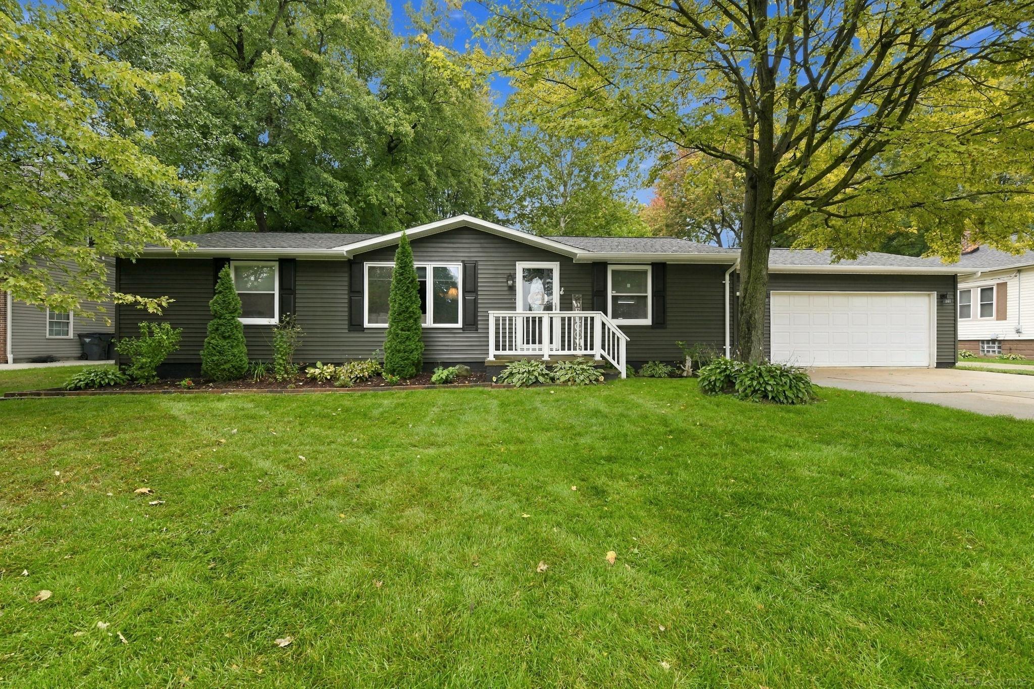 OPEN HOUSE: Saturday, October 3rd from 1-3pm.  Welcome home to this move-in-ready three-bedroom property, featuring a beautifully appointed kitchen with detailed cabinetry, granite countertops, a spacious island, recessed lighting, and stainless steel appliances. A door wall opens to the park-like backyard-ideal for outdoor dining, entertaining, or relaxing. Additional highlights include a split layout with a new primary bathroom, an updated main bath, and oak flooring in the living room and kitchen. Improvements completed within the past six years include a new garage door, exterior painting, central air conditioning, and a hot water heater. The roof was replaced in 2017.