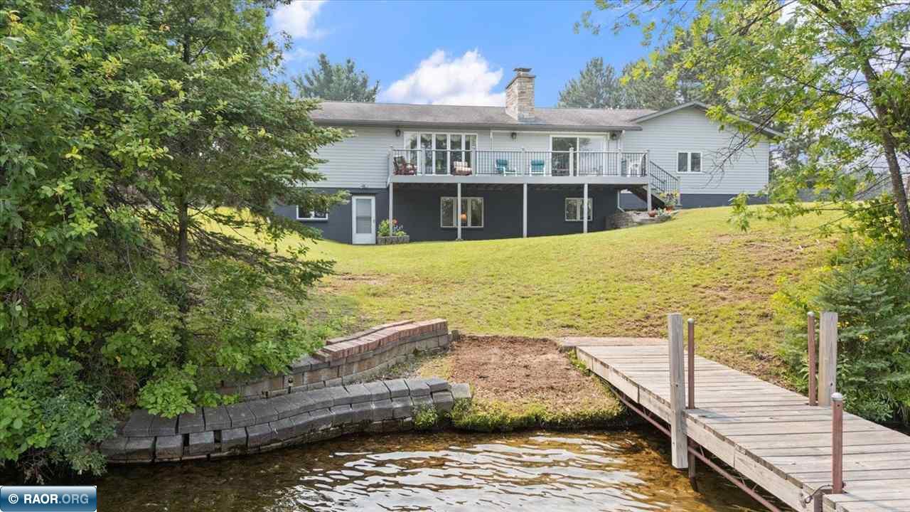 Lake life doesn't get better than this on desirable Ely Lake, featuring 230 feet of sandy shoreline and breathtaking sunset views. This 3 bed, 3 bath home offers 2,850 sq ft with spacious living areas and beautiful lake views throughout. The main floor features a two sided fireplace for those chilly nights, large windows, and access to an expansive lakeside deck perfect for entertaining. The open kitchen includes stainless steel appliances and new LVP flooring, with additional new LVP flooring throughout the lower level and new carpet in the living and dining rooms. The lower level also offers additional living space with a fireplace and walkout access to the lake. Enjoy your private dock and close proximity to parks, trails, tennis courts, an ice rink, schools, and town. Exceptional lake living ready for you!
