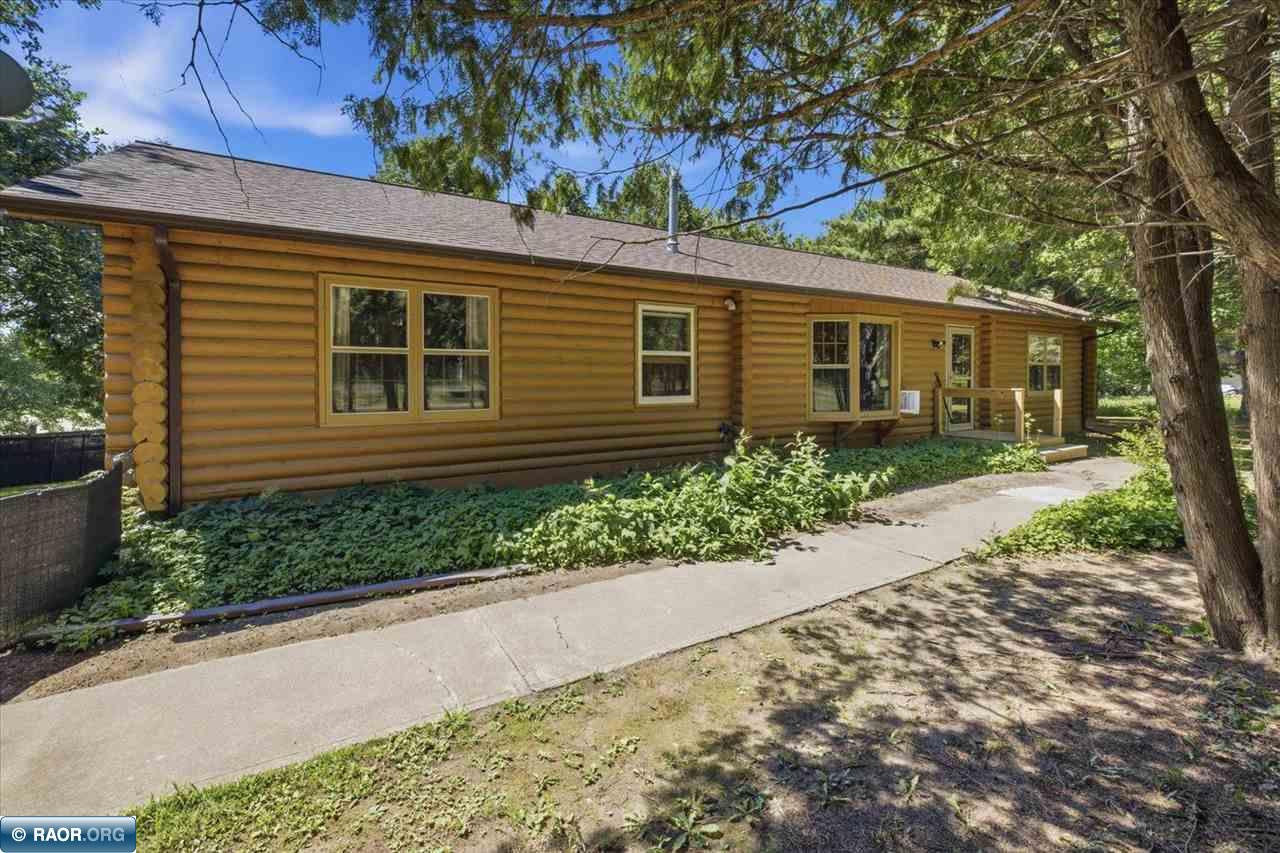 Enjoy the ease of one-level living in this charming 4-bedroom log home situated on approximately5.45 acres. The open-concept living room, dining area, and kitchen create a warm and inviting space for gathering with family and friends. Built on a cement slab  & heated crawl space, this home offers comfort and efficiency year-round. Perfect for horse enthusiasts, this property is thoughtfully equipped with a fully insulated barn featuring two horse stalls, electricity, and screened doors to provide excellent ventilation and happy horses. Additional outbuildings include a hay barn, a run-in shed for shelter and fly protection, an insulated two-stall garage, and a separate one-stall garage, providing plenty of space for vehicles, equipment, and storage. Two fenced pastures offer room for your horses to roam, while the small pond (Anderson Lake) adds to the peaceful country setting. Surrounded by beautiful oak trees, this unique property offers the perfect set up for horses.