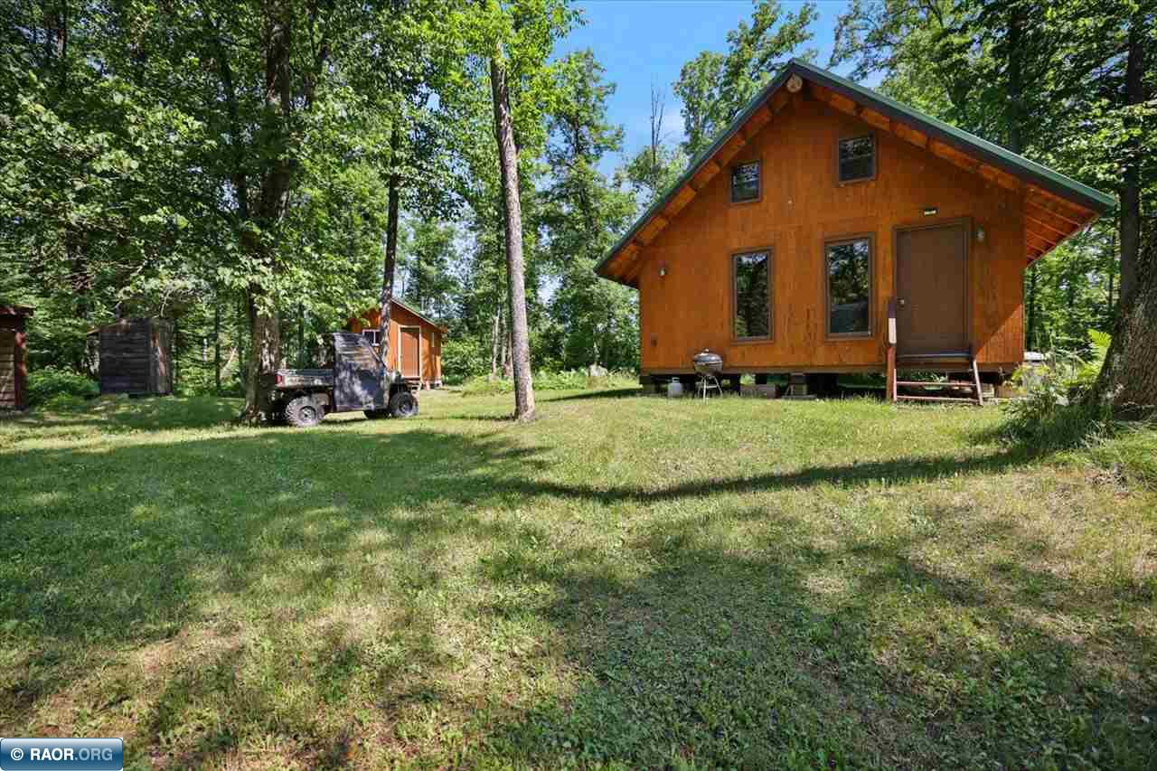 A rare riverfront retreat on 31.8 beautiful acres! Tucked into the woods, this cabin offers warm Northwoods character with a vaulted wood interior, exposed log accents, kitchen and living areas, two sets of queen-size bunks and a wood stove. Both the cabin and impressive cedar sauna are wired for electricity powered by generator, a compliant privy, and covered woodshed with ATV parking completes the setup. Explore an extensive network of mapped trails, then follow the short trail to the river, where approximately 1/4 mile of stunning river frontage, a fire pit and woodshed create an unforgettable place to gather. The property also adjoins 100+ acres of state land, expanding the recreational possibilities. Meticulously cared for and ready for its next chapter. Furnishings go with the sale along with the Honda 2000 watt generator. Come unplug, explore and make memories here!