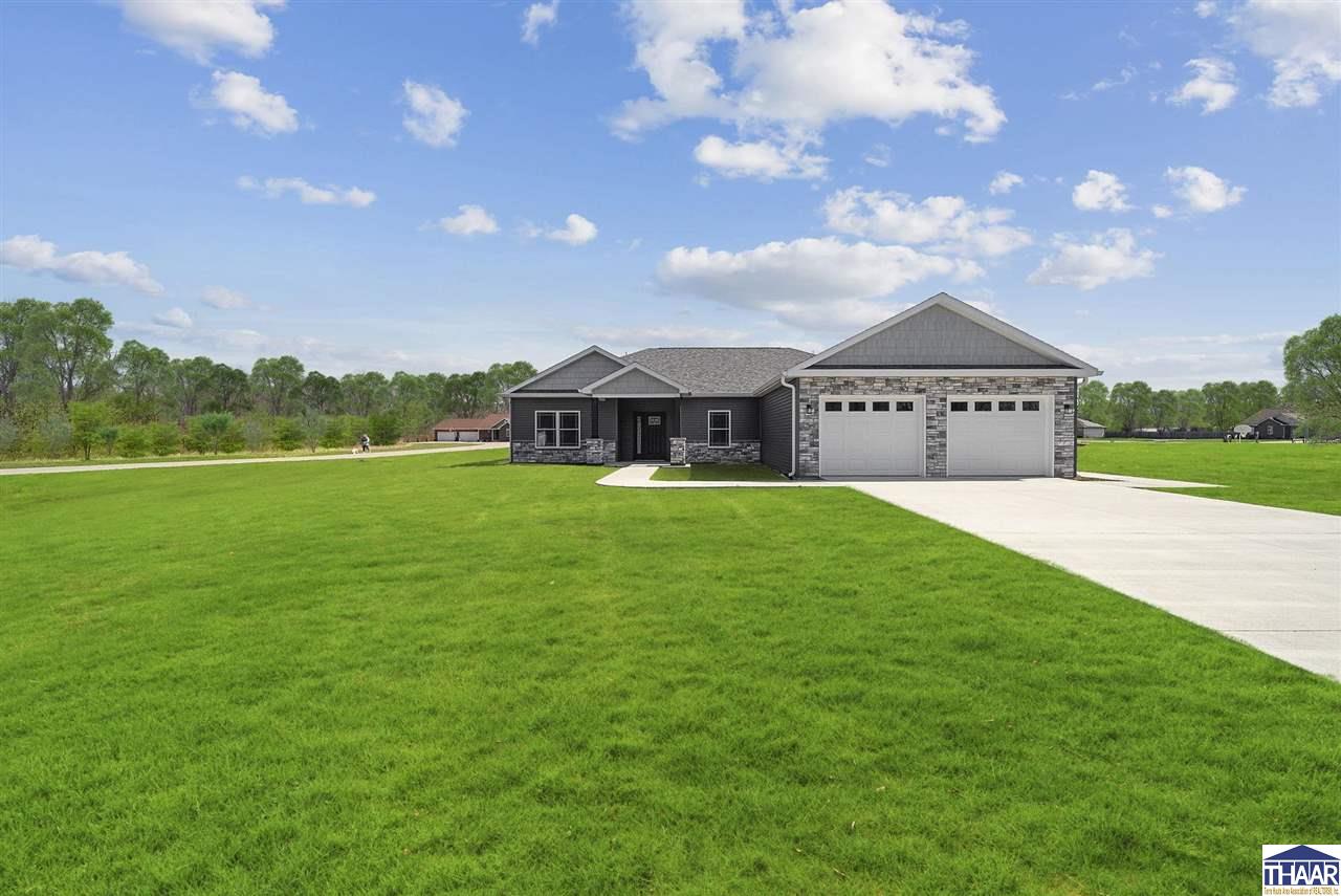 Some photos are virtually staged to help you better visualize the space. Discover this newly built ranch home located in a rural subdivision setting on a spacious corner lot, offering 3 bedrooms, 2.5 baths, and a highly functional split floor plan. The open layout creates a natural flow between the living, dining, and kitchen areas—perfect for both relaxing and entertaining.  The kitchen stands out with granite countertops, a large island, and plenty of workspace. The primary suite provides a private retreat with a walk-in closet and en-suite bath. A covered patio with ceiling fan extends your living space outdoors, while the attached garage adds convenience and storage.  Enjoy the peace of mind that comes with brand-new construction, modern systems, and a builder warranty. With thoughtful design and quality finishes throughout, this move-in ready home is ready to enjoy from day one.