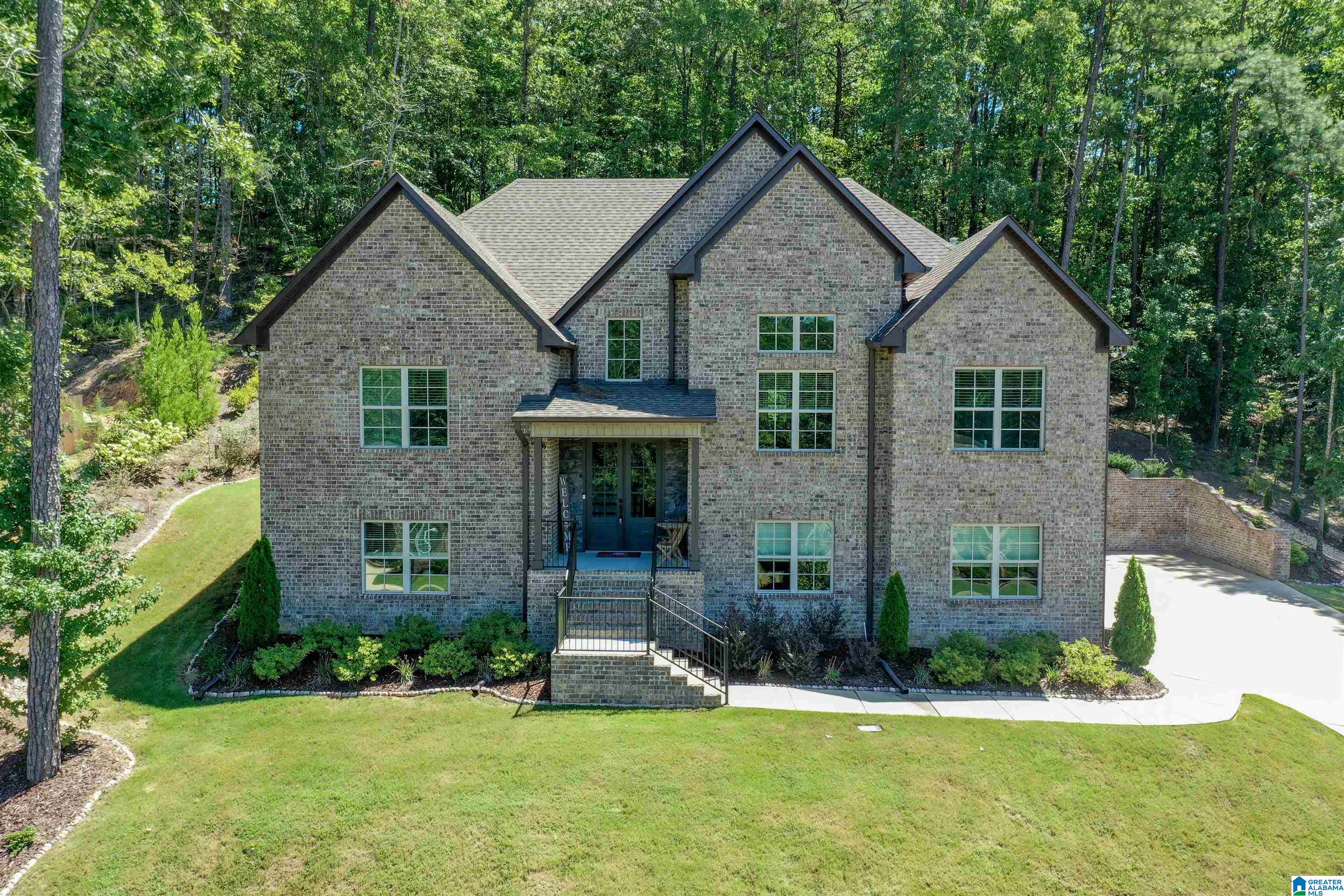 BETTER THAN NEW! 4 car garage, soaring ceilings, expansive space, beautiful yard, too much to list. The Sarah plan will not disappoint! Empressive 2 story foyer upon entry with gleaming hardwoods throughout the main level living areas. The kitchen is an entertainers dream with a 7' island, quartz tops, gas range, and ample counter space. It opens seamlessly to the family room, dining room and a cozy keeping room w/fireplace that flows beautifully for easy living. The oversized master suite is situated on one end of the main level and boasts an elegant bath with soaking tub, double vanities, tiled shower and an AMAZING closet. Two additional bedrooms and a full bath are on the opposite end of the main level. Basement is anyone's dream with a large den, bedroom, dedicated office or 5th bedroom and a full bath. Outdoor entertaining is easy with your screened porch, million dollar views of the mountains, a patio area with firepit and complete privacy in your backyard.