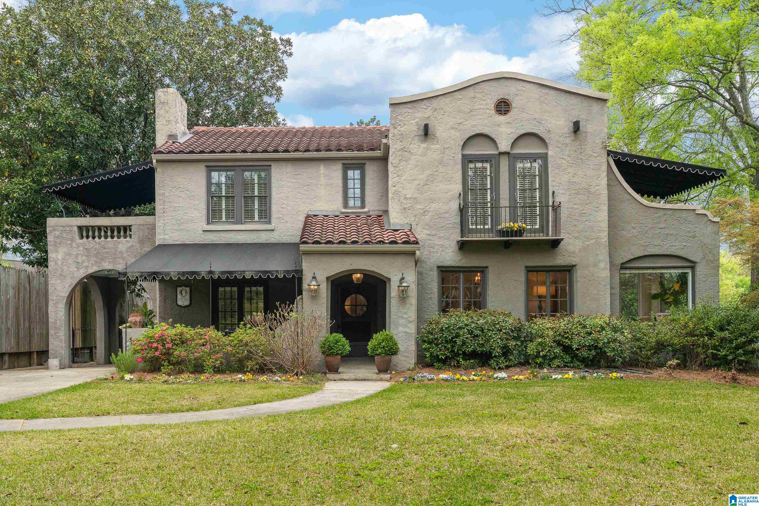 Located in Homewood’s historic Hollywood neighborhood, 12 Bonita Drive blends 1928 charm with thoughtful modern updates. Recognized by the Jefferson County Historical Society, this home offers walkability to Shades Cahaba Elementary School, and downtown Homewood. Set on a large, landscaped lot with Japanese maples, gardens, and a goldfish pond, outdoor living includes a spacious deck with gas/water connections, gated porte-cochère, and parking for 6-7 cars plus detached garage. Inside, original details—Moroccan arches, leaded glass, and stone fireplace—pair with refinished hardwoods, recessed lighting, central vacuum, and four-zone HVAC. The custom kitchen features Thermador appliances, Dacor refrigeration, and a statement island with a historic soapstone sink. Upstairs offers a private primary suite, flexible bedrooms, and covered decks. Extensive updates include a tile roof, reverse osmosis water system encapsulated crawlspace, and irrigation system. A rare opportunity in Hollywood.
