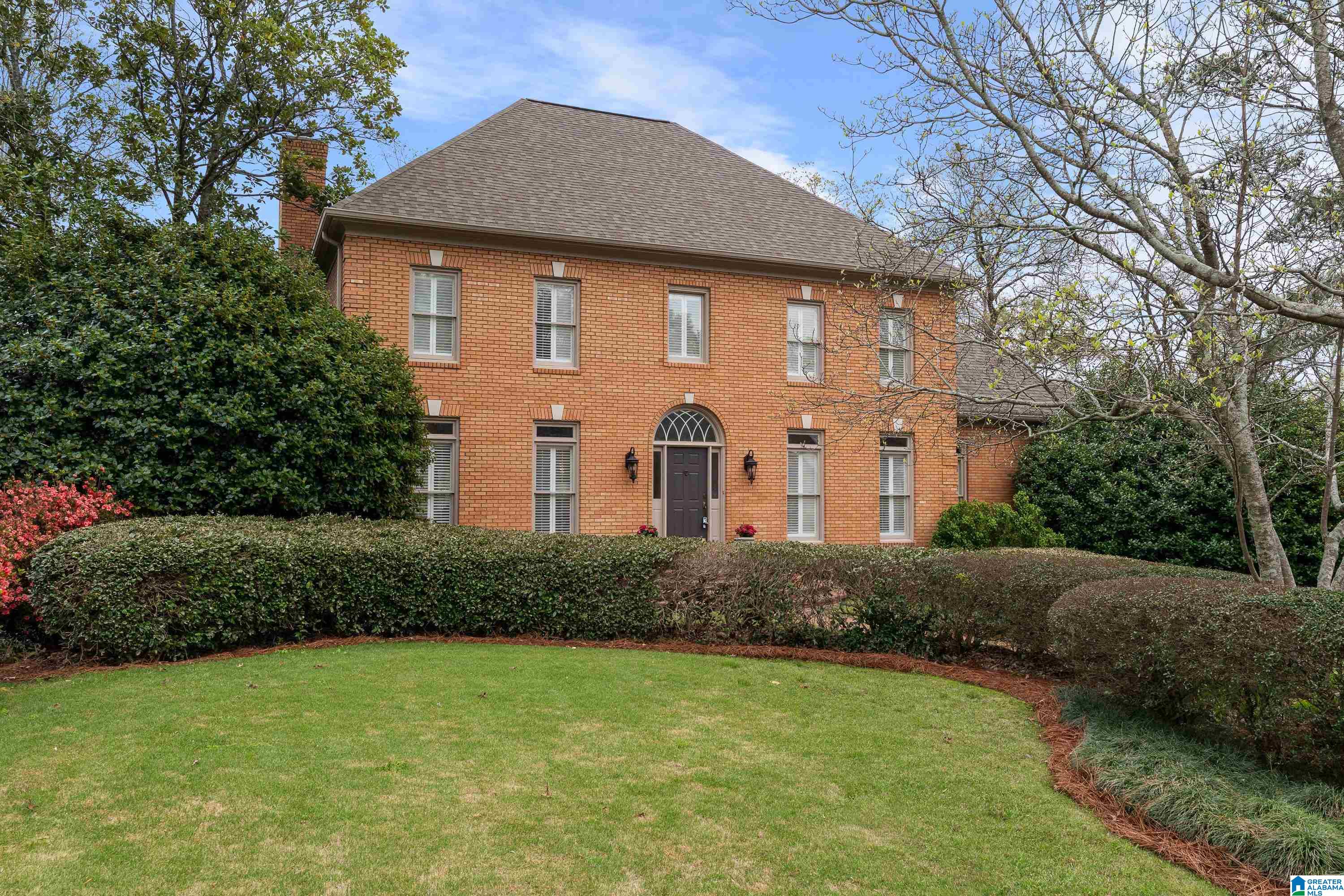 Stately brick home nestled on a quiet Cherokee Bend street. Step into a foyer w/ soaring ceilings that leads into a light-filled living room. The family room features a fireplace w/ built-ins & flows seamlessly into the spacious kitchen offering abundant cabinetry, an island & a large eat-in area w/ access to the open deck—perfect for indoor/outdoor entertaining. The impressive primary suite features tall ceilings & a well-appointed ensuite bath w/ 2 vanities on opposite sides, 2 walk-in closets & a soaking tub w/ a separate shower. Upstairs, a loft provides additional living space & leads to 3 spacious bedrooms—1 w/ a private ensuite, 2 share a Jack-&-Jill. The finished basement expands the home & opens to a covered back patio. This level also includes a den w/ built-ins, a kitchenette, convenient half bath, exercise room & 5th bedroom w/ a full ensuite. Large, flat backyard is beautifully framed by mature landscaping & a brick fence, complemented by a 2-car garage & front parking pad