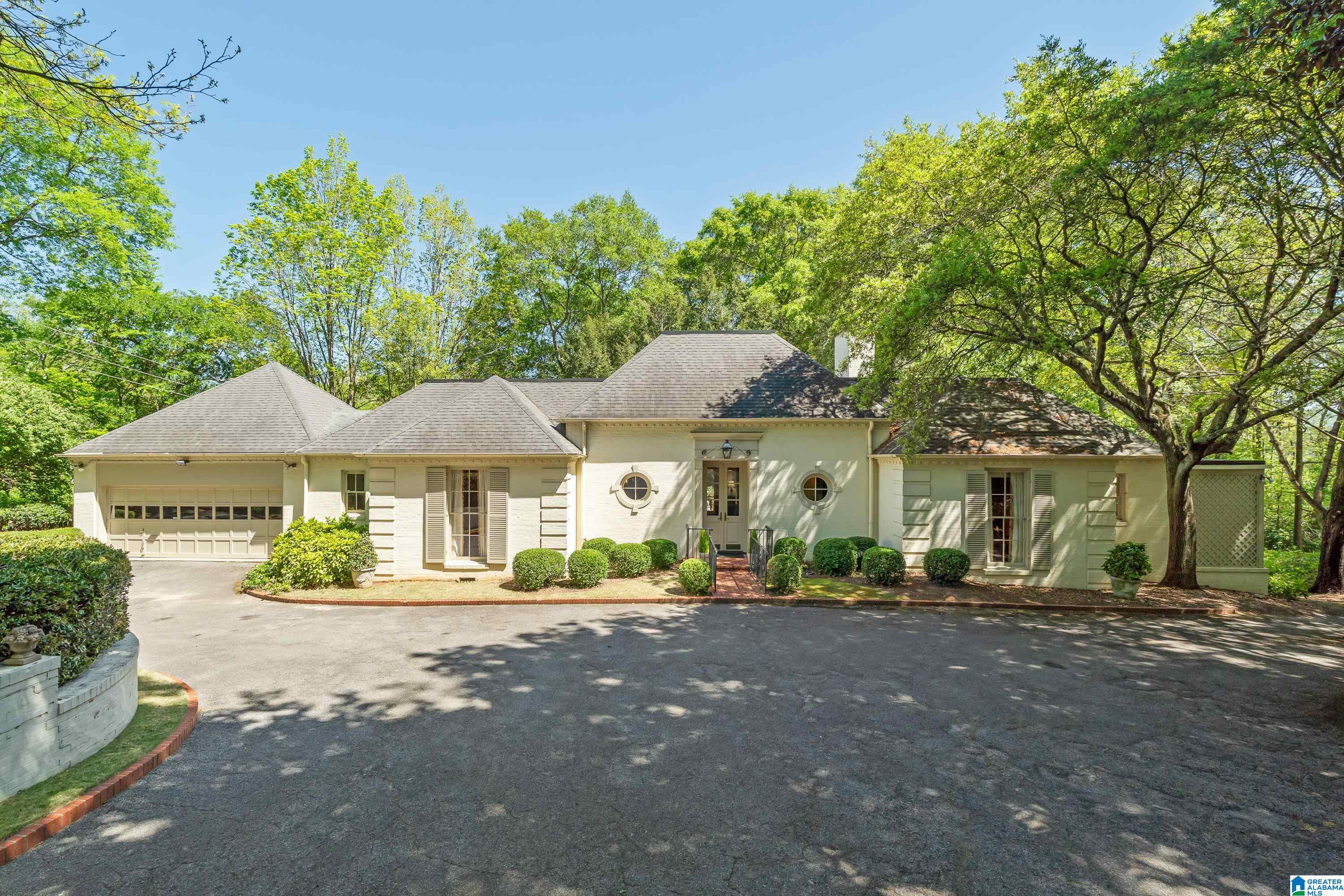 Welcome to 3238 Country Club Road ! Drive up and around to front Motor Court Parking. Enter lovely Marble Floored Foyer! Large rooms, Tall Ceilings,Custom Cabinetry & Shelving,Crown moldings, Hardwood Floors and some Floor to Ceiling Windows! Primary bedroom w/ double bathrooms , walk in closets, Fire place and sitting area.Second bedroom on main with private bath. Spacious Kitchen off of Great Room with eat in area, lots of cabinets, Redone Kitchen in 2007, Appliances (hardly used). Kitchen has a look through into Great Room.  Great Room and Kitchen open to Large Outside Terrace ! Dining room, Half bath , Laundry and Garage on main level. Downstairs Third Bedroom , Bath , Large Den/ Rec. room  and tons of Storage rooms, Closets. Downstairs Bedroom, Den have a view of  front yard !Beautiful property! Private but close in to all three Mountain Brook Villages!  Custom Built Home ! Truly a Gem !