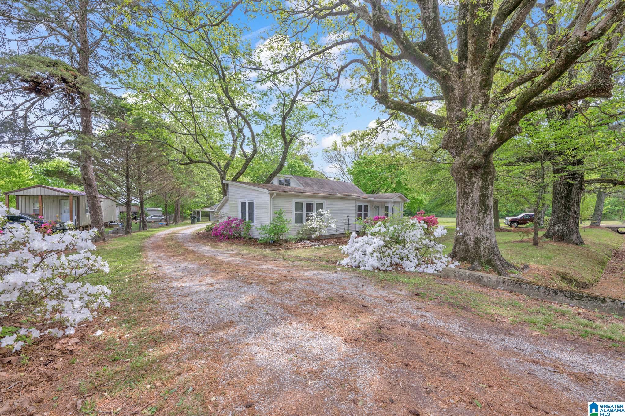 Once in a lifetime opportunity!  An exceptional home looking for an exceptional family.  This 4 bed 3 bath home with a workshop sits on 4 acres in an idyllic setting.   The home features two LARGE master bedrooms on the main level and two more bedrooms upstairs. There is an exceptional amount of storage in this home.  The living areas including a spacious family room and a generous sized dining room.  The primary kitchen has great cabinet and countertop space - enough room for a breakfast table as well.    The secondary kitchen/laundry area is a perfect location for canning, crafts, etc.  Home has an enormous walk in pantry.  The property includes a workshop that is perfect for a home business or storage and hobbies.  You will love the serene evenings on the porch swing, taking in the evening breeze!