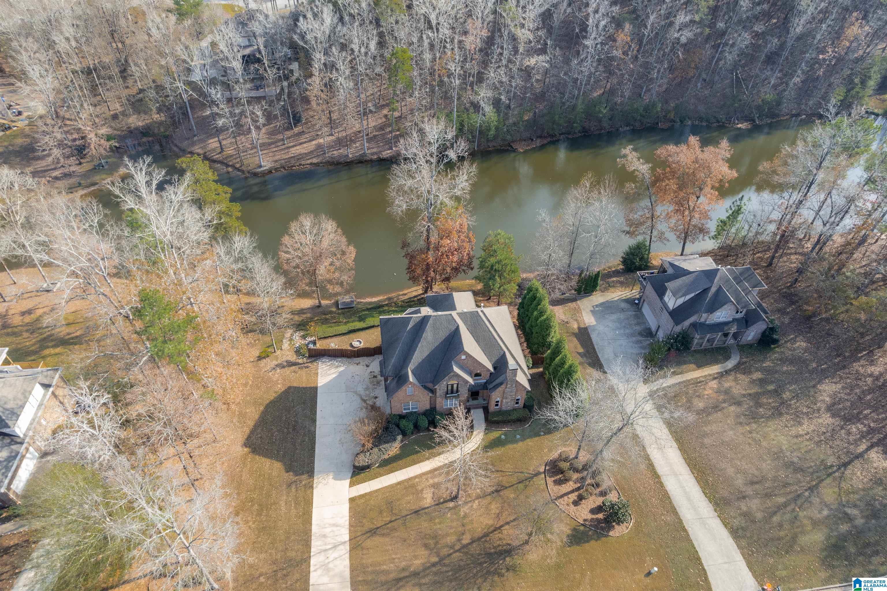 Lakeside living in TIMBERLAKE ESTATES - SHELBY COUNTY / HELENA - Lovely 4BR/3.5BA home with full basement! Step onto the screened deck overlooking the water—perfect for morning coffee or golden-hour sunsets. and a private DOCK, just steps from the Timberlake community POOL -CLUBHOUSE. This property offers a main-level Master Suite plus a second main-level bedroom with ensuite bathroom. Exceptional features include a whole-house 22KW auto-switch generator, hardwood floors throughout the main level, coffered, vaulted and trey ceilings, arched entryways, and a built-in desk nook. The open eat-in kitchen showcases quartz countertops and stainless appliances with a gas cooktop. The Master Suite features a vaulted sitting area and a Travertine spa bath with dual comfort-height vanities and two linen closets. Upstairs are two additional bedrooms, a bonus room, and a full bath. The full finished basement provides incredible flexibility for a media room, gym, or office with walkout basement.