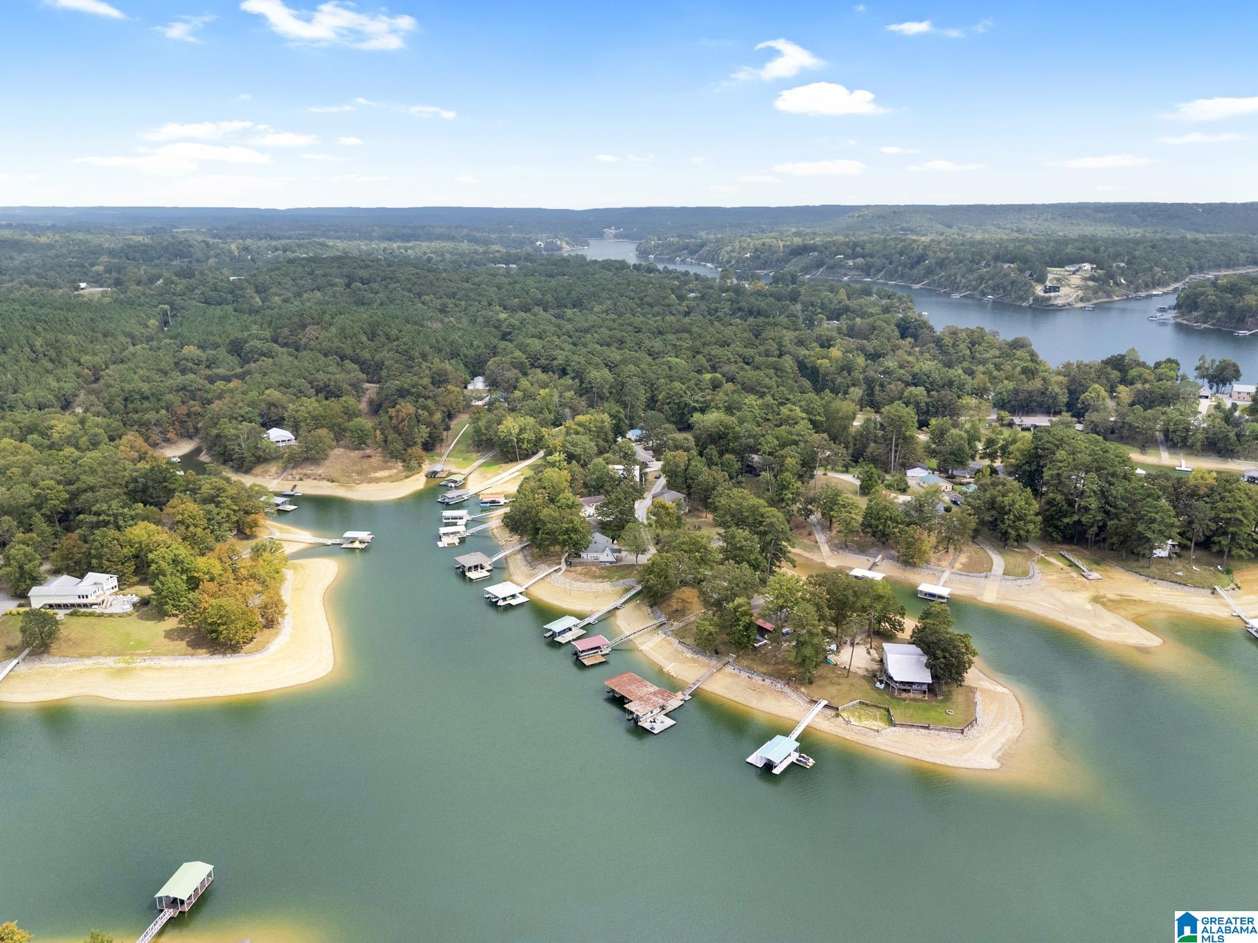 RARE lakefront property on Catalina Point. Situated on a quiet, low-traffic slough just minutes from Cullman and I-65 Exit 304, this property offers one of the most desirable settings on Smith Lake. Featuring year-round deep water and an established dock/slip setup, the standout feature is the incredibly gentle slope with little to no steps leading right down to the water's edge. The cozy 2 bedroom, 1 bath home showcases a gorgeous, expansive screened-in back porch and a wonderful open deck perfect for taking in the stunning open water views. This property presents an incredible opportunity for a weekend retreat or your future home!