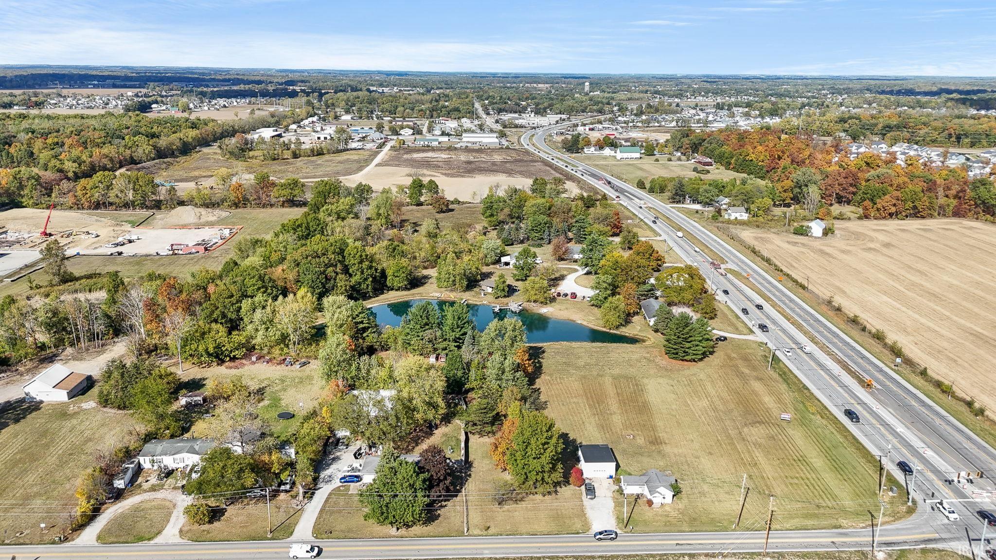 Aerial overview of property's location featuring a nearby body of water and a major roadway