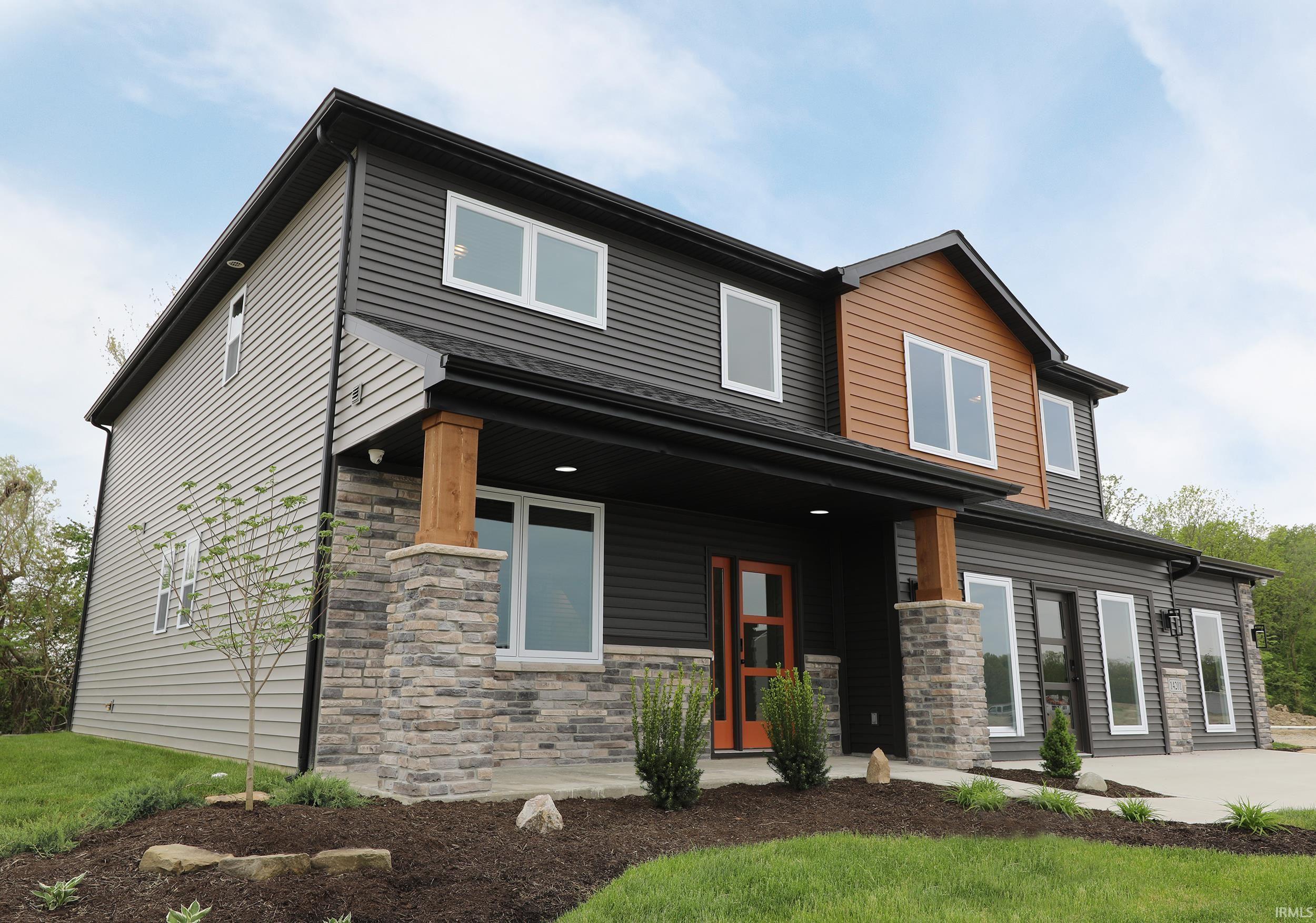 Contemporary exterior with dark siding and light wood-tone accents