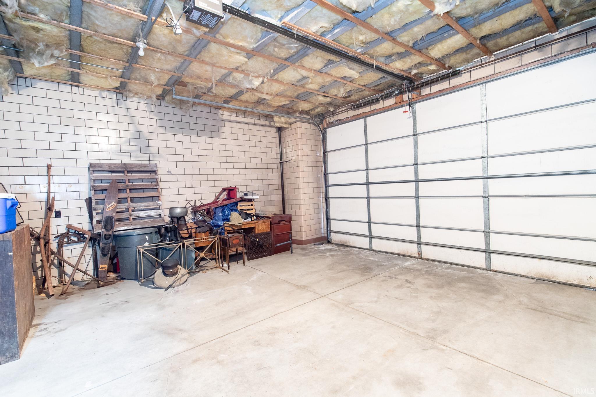 Oversized Garage access on east side w/12' + OH door.