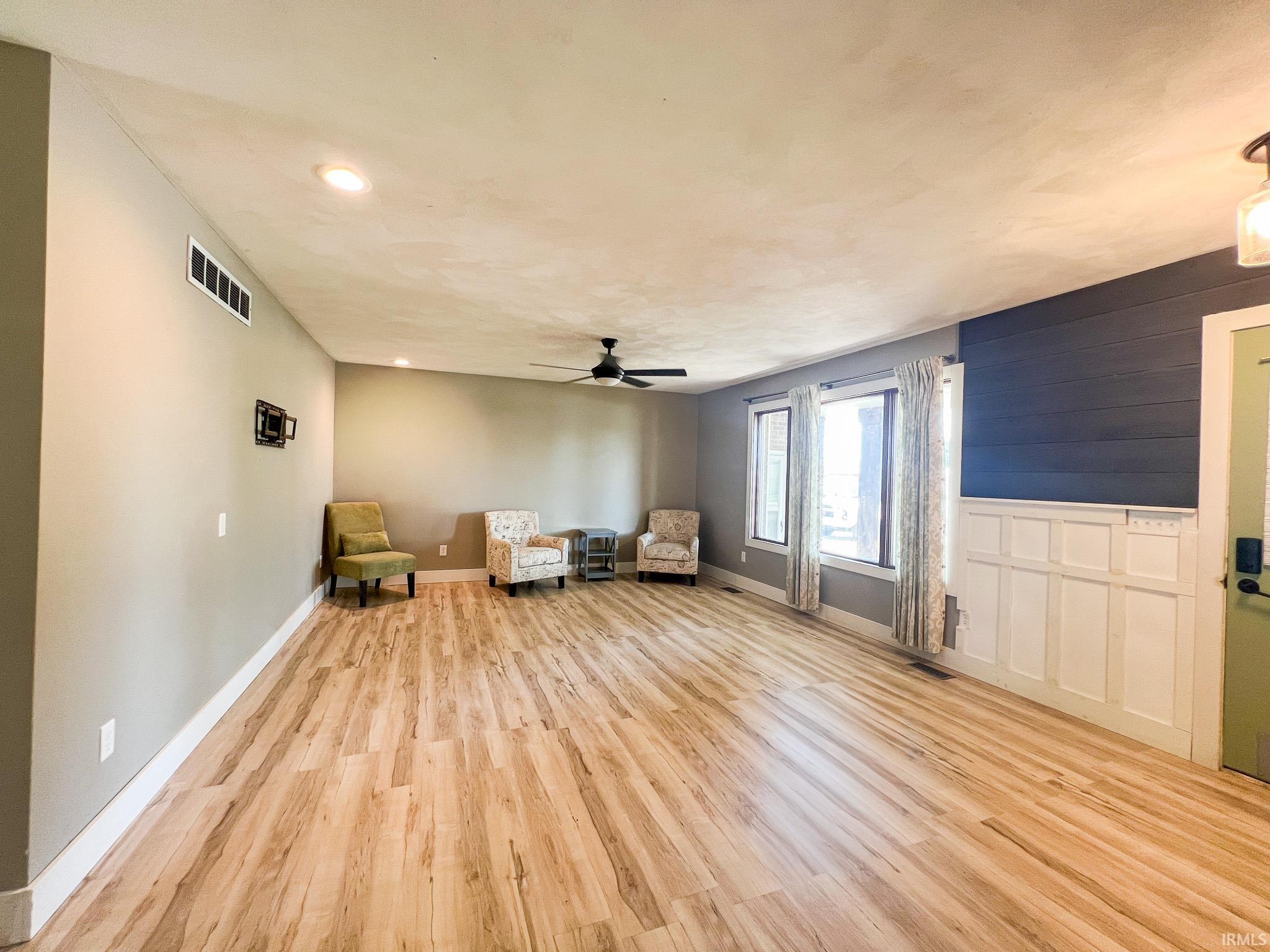 Living room with light wood-style flooring, recessed lighting, and ceiling fan