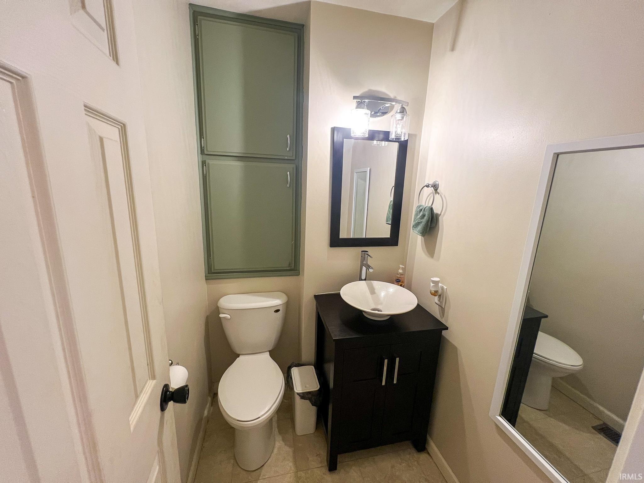 Bathroom featuring vanity and light tile patterned floors