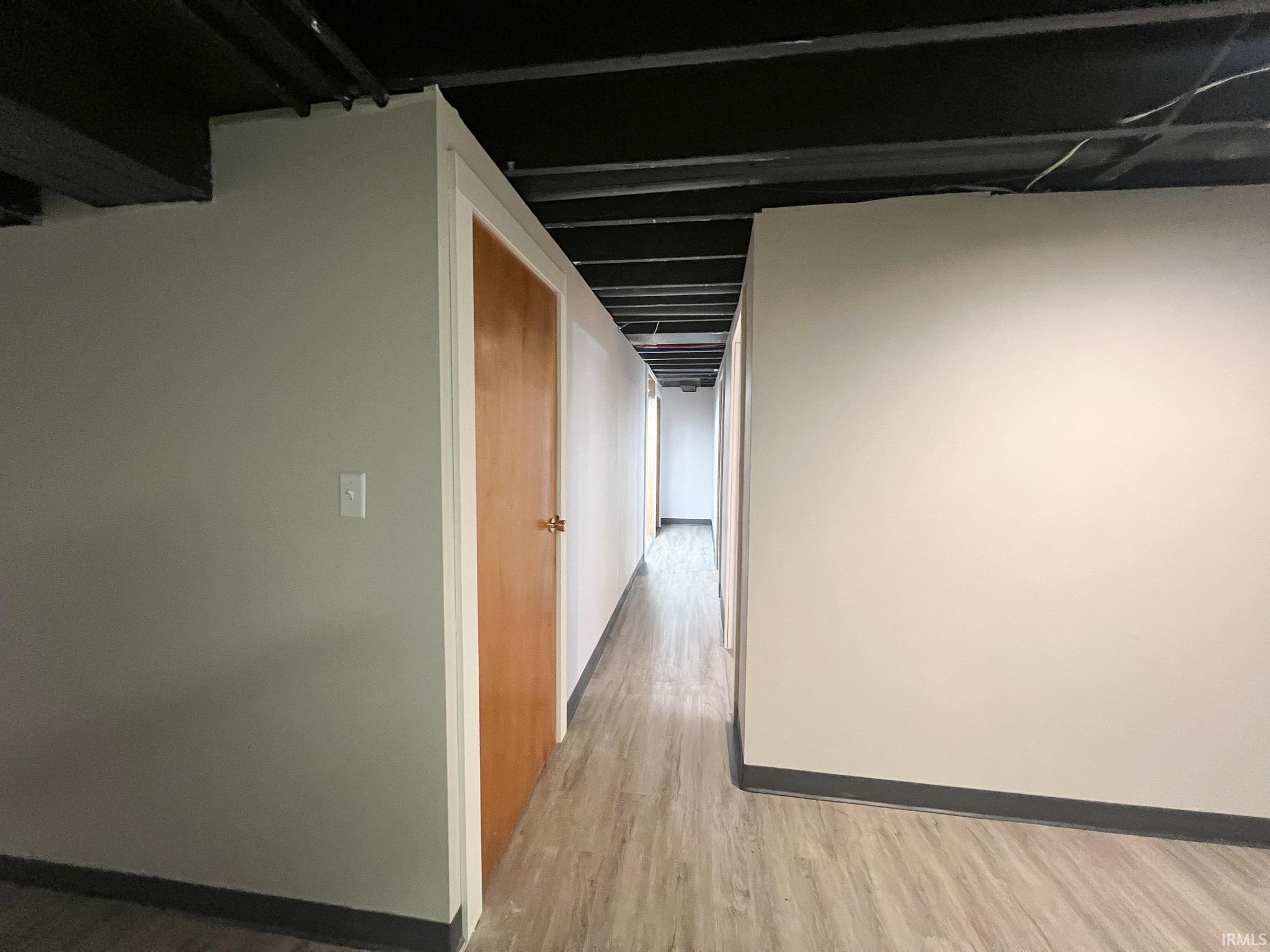 Hall in basement light wood finished floors