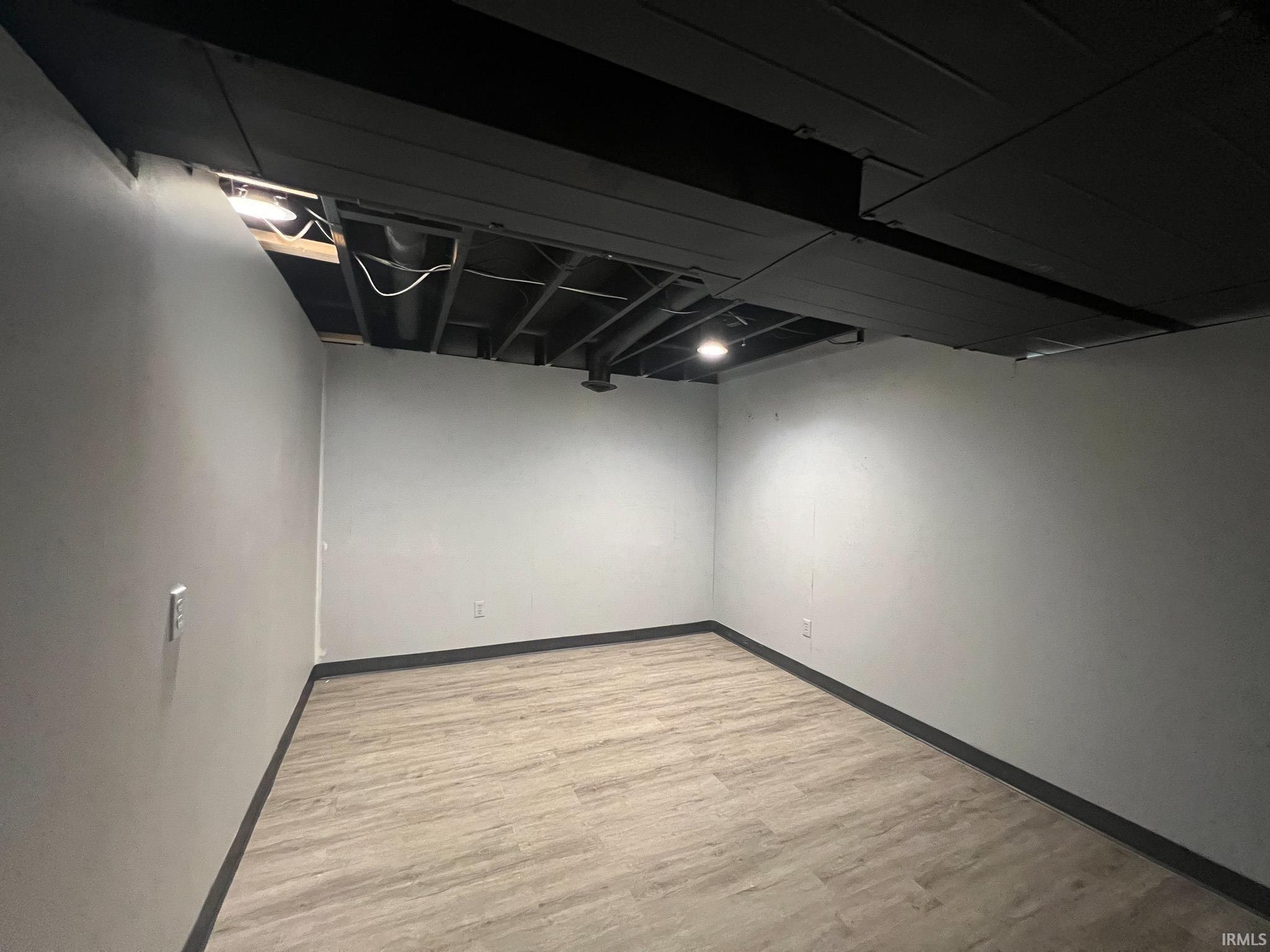 Potential bedroom in basement featuring light wood-type flooring and closet, no egress window.