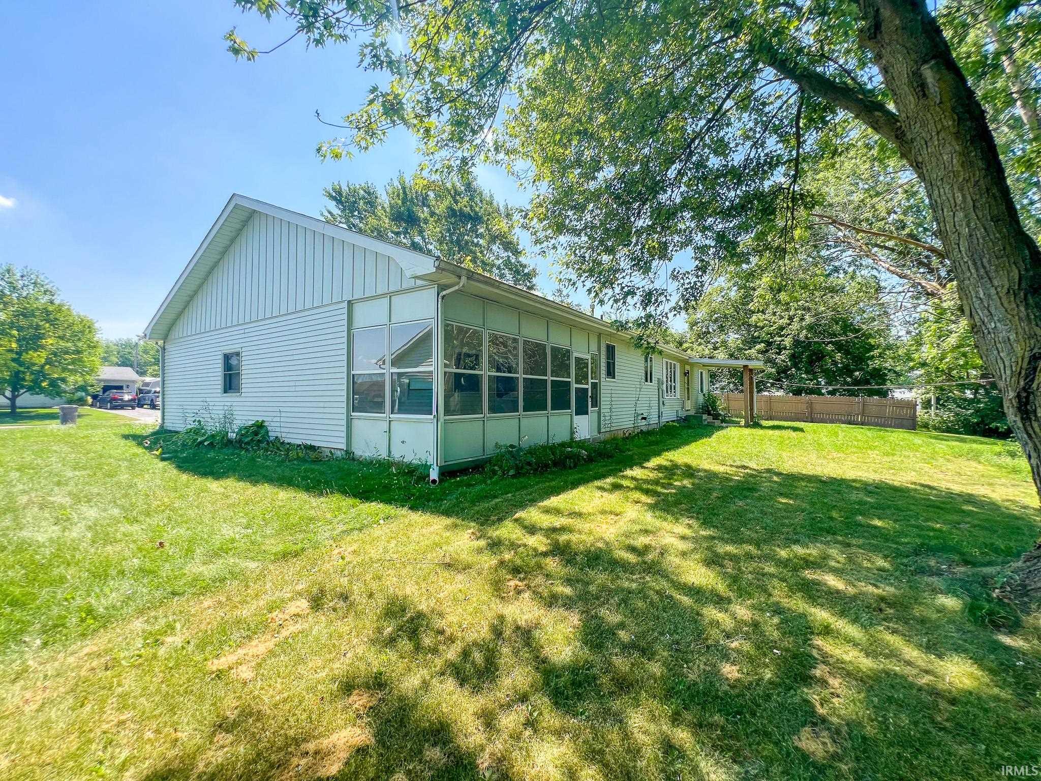 View of side of property featuring a sunroom