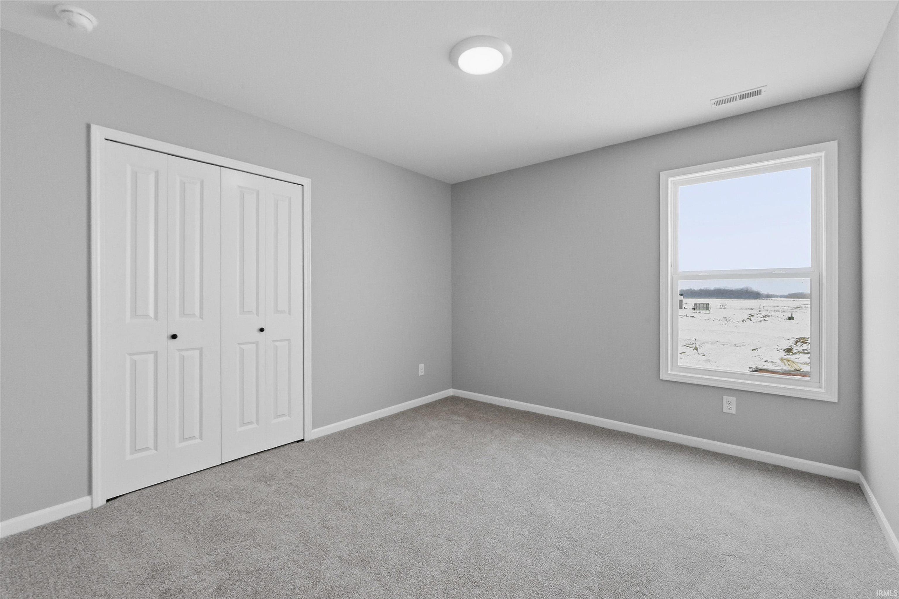 Unfurnished bedroom with a closet and light carpet