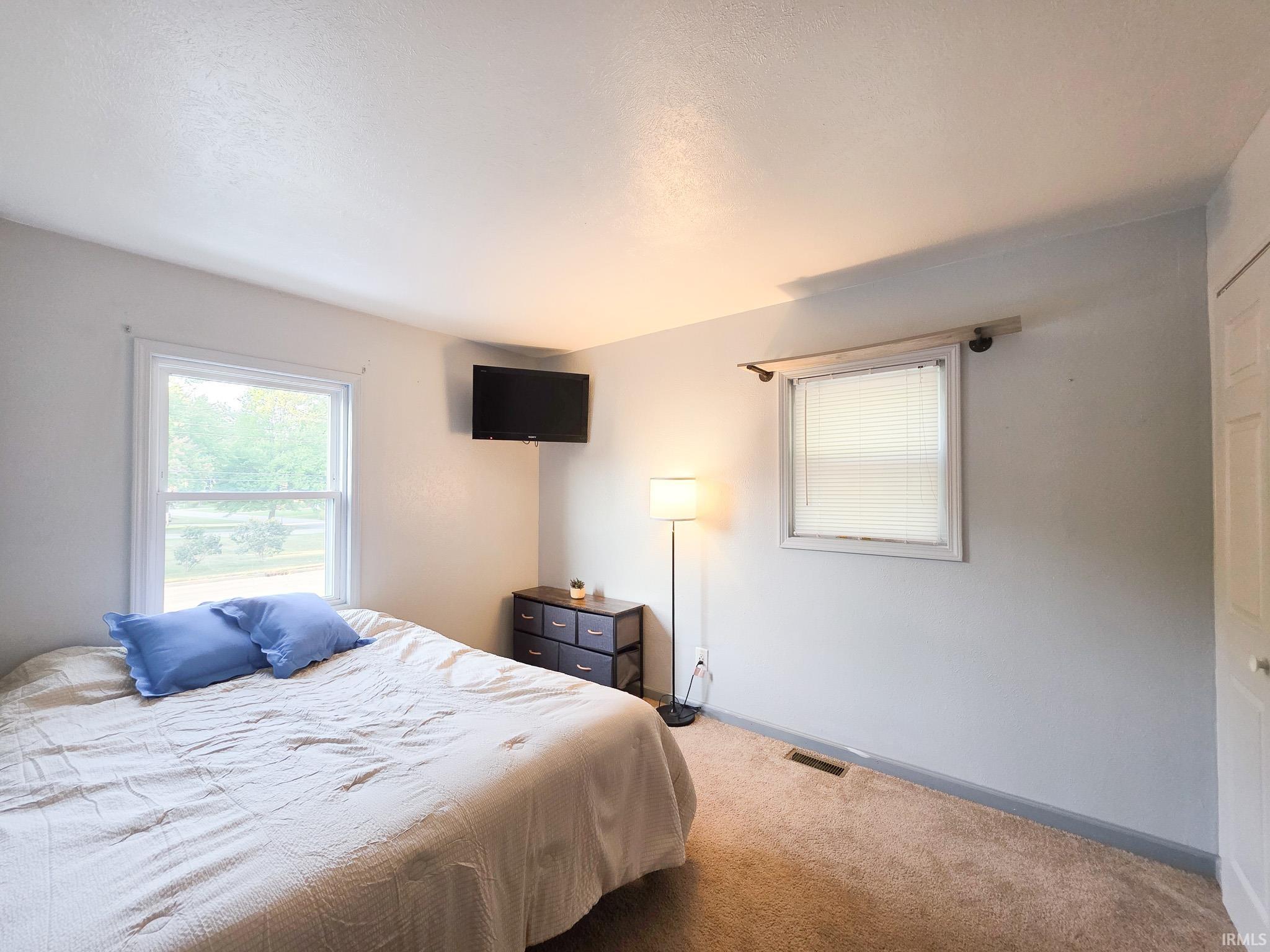 Bedroom featuring baseboards and carpet flooring