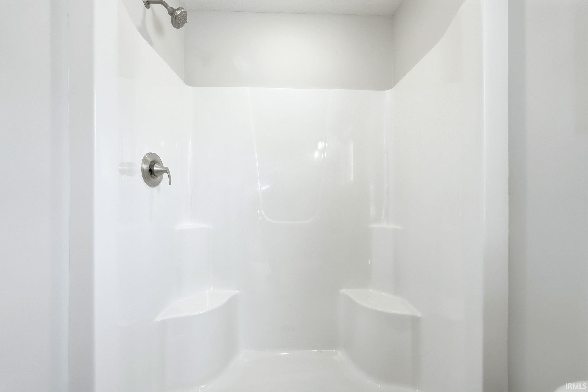 Full bathroom featuring a stall shower