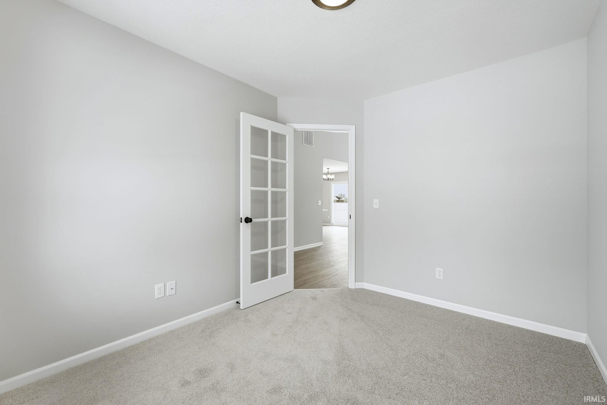 Carpeted empty room featuring baseboards