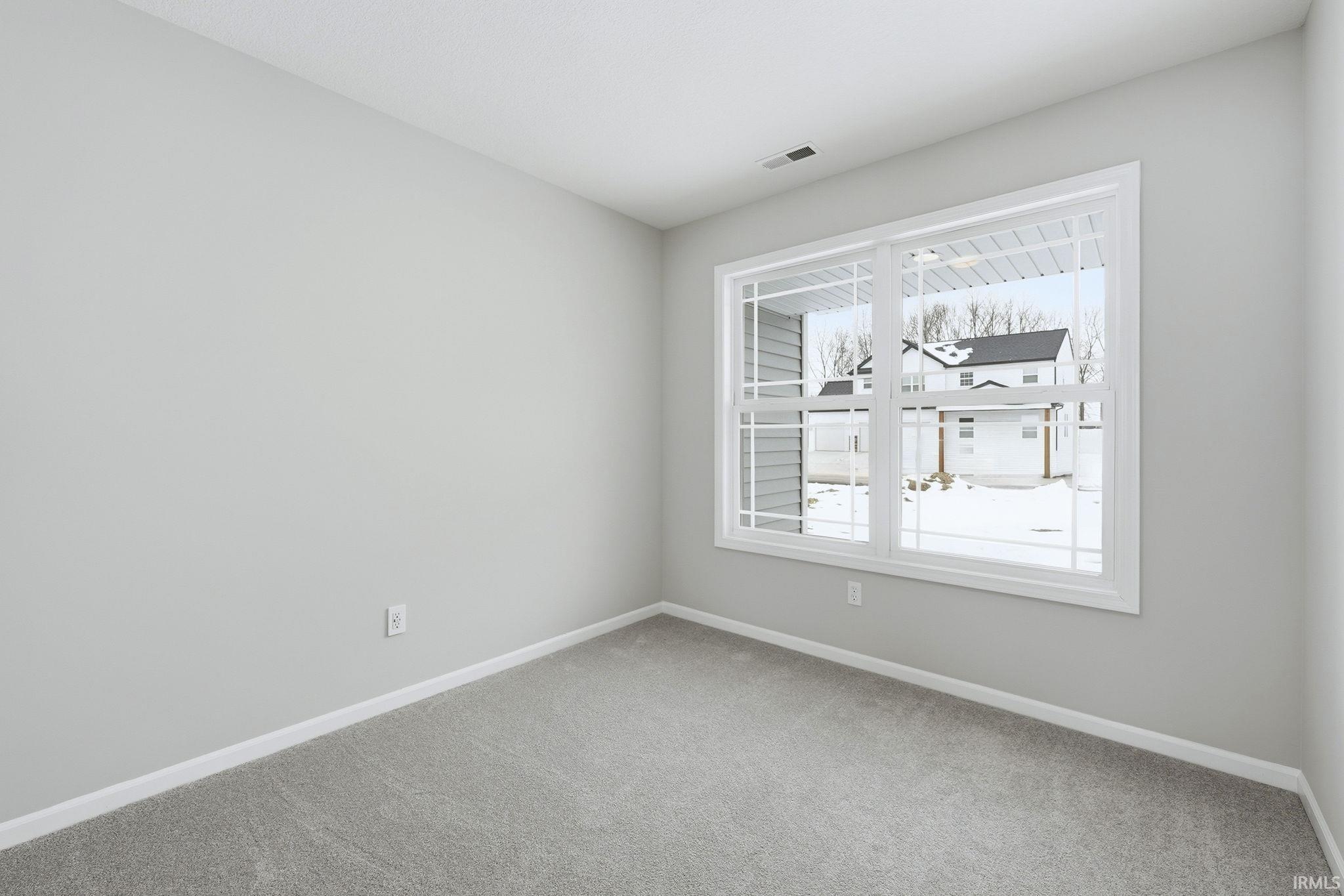 Unfurnished room featuring baseboards and carpet flooring