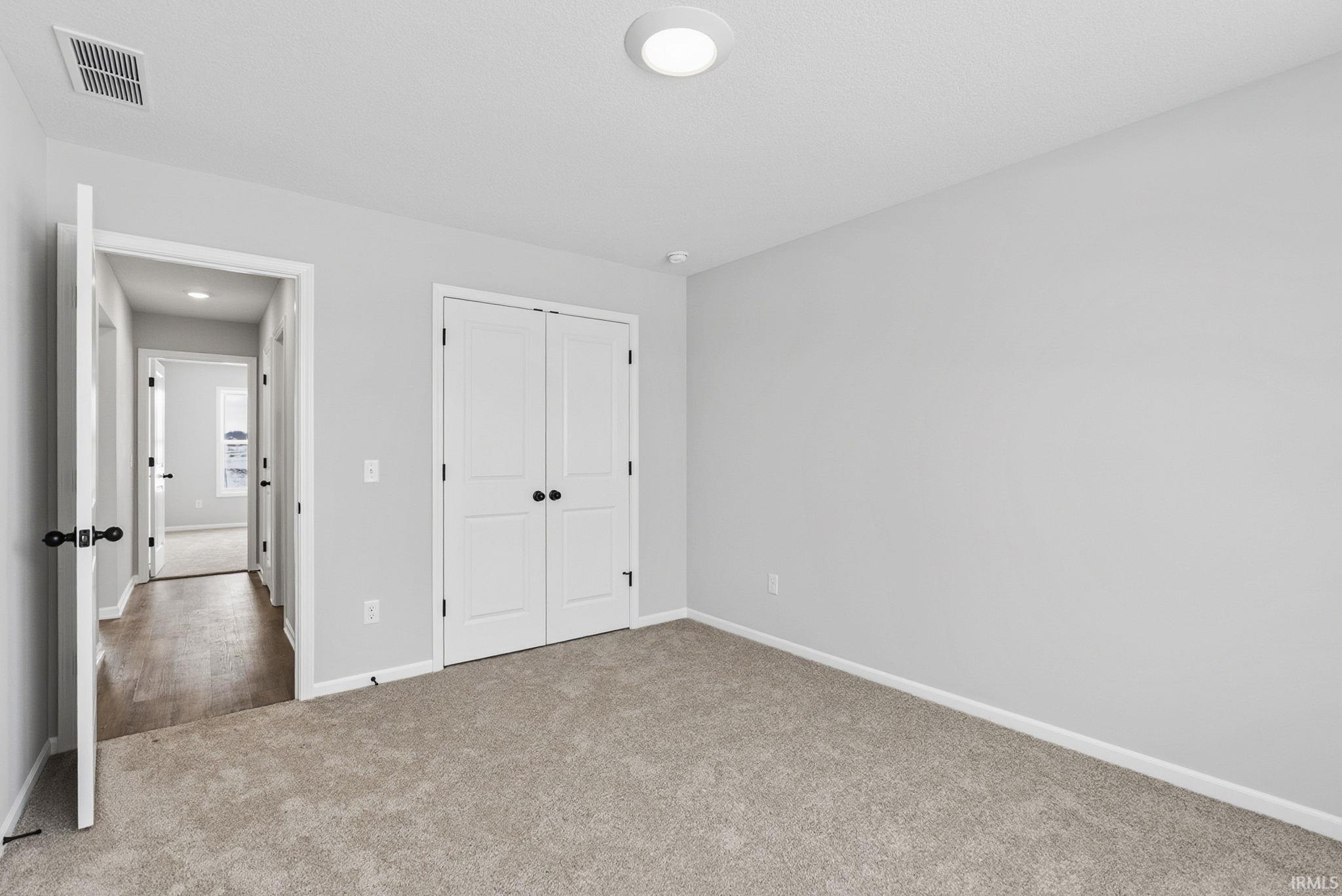 Unfurnished bedroom with carpet floors and a closet