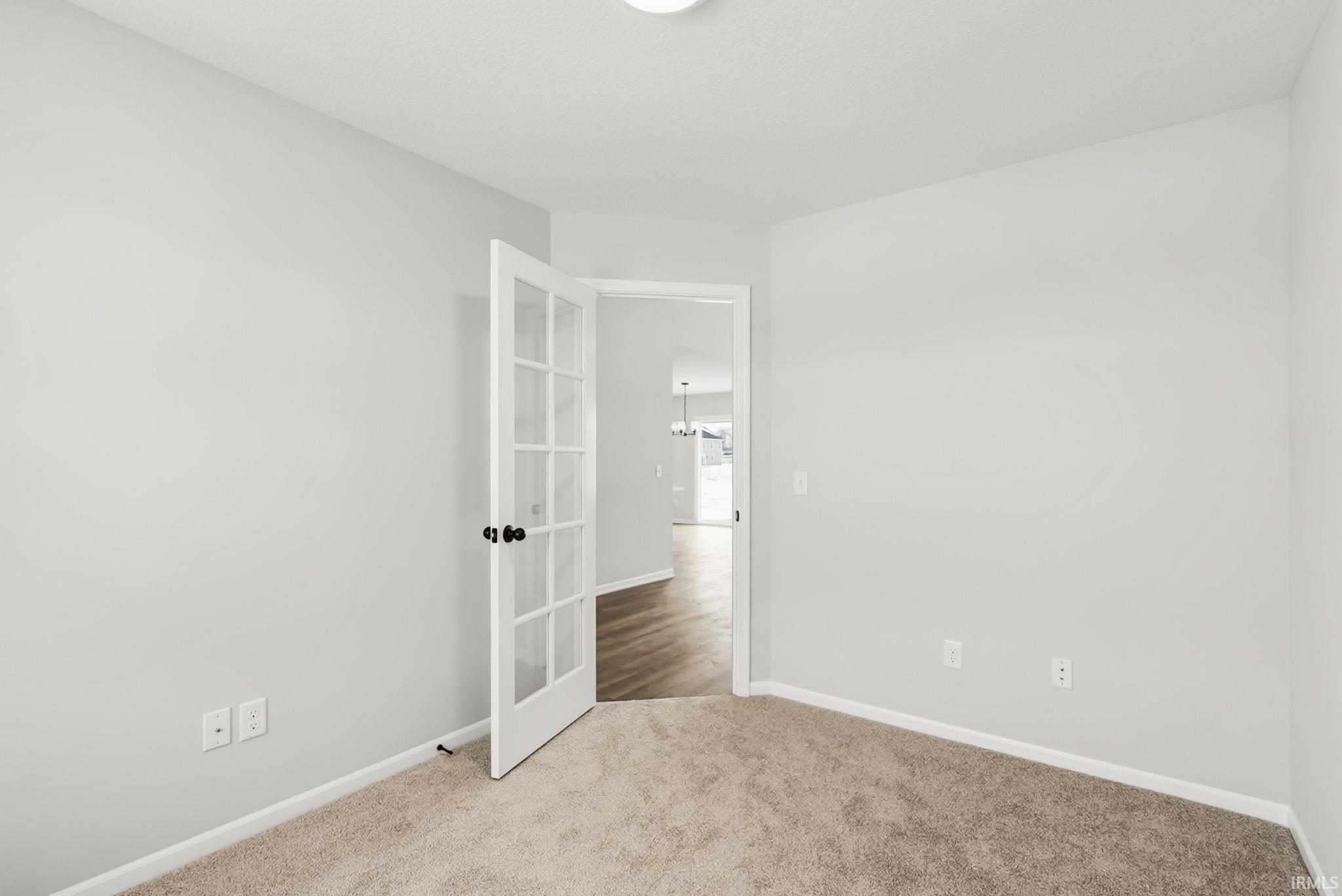 Unfurnished room with baseboards and carpet flooring