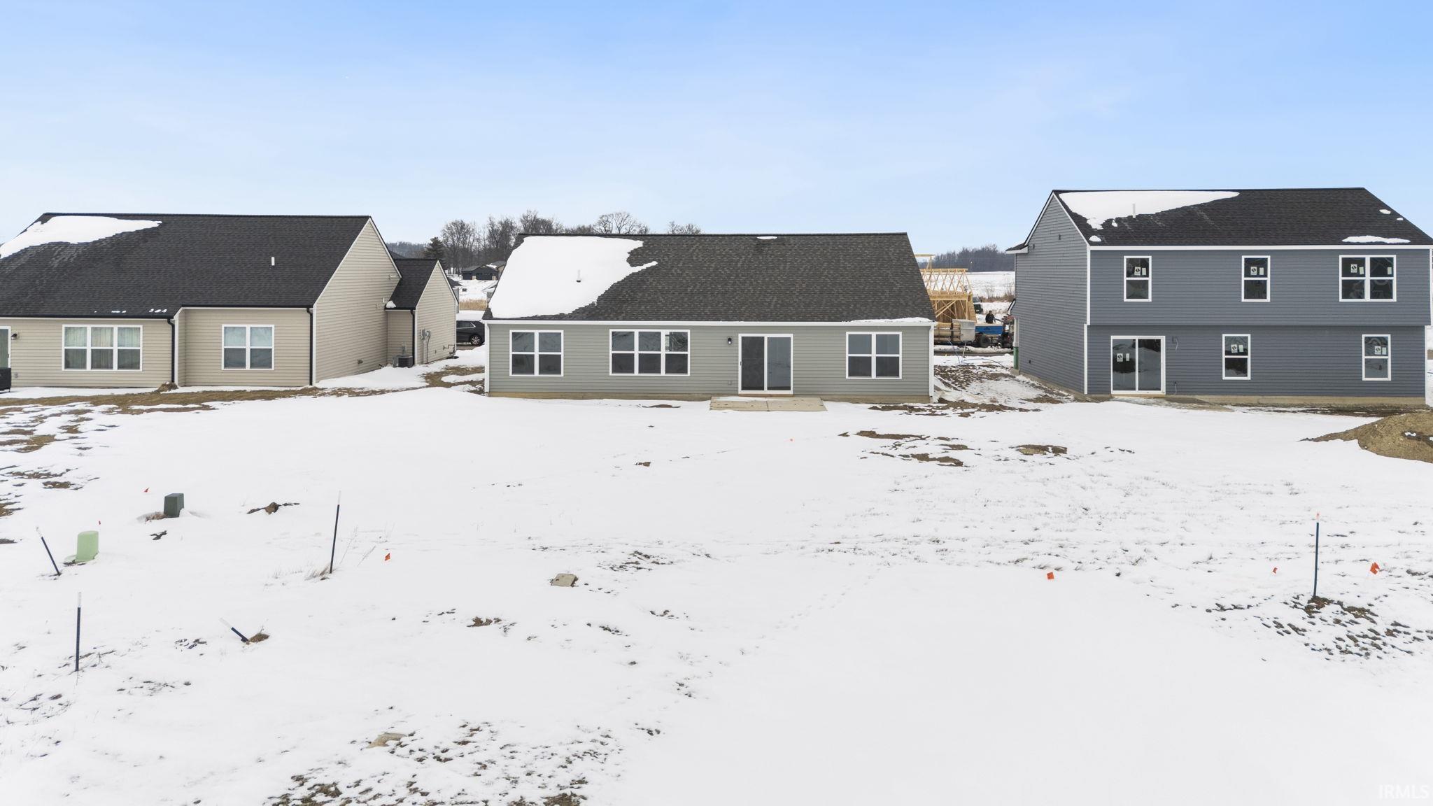 View of snow covered rear of property