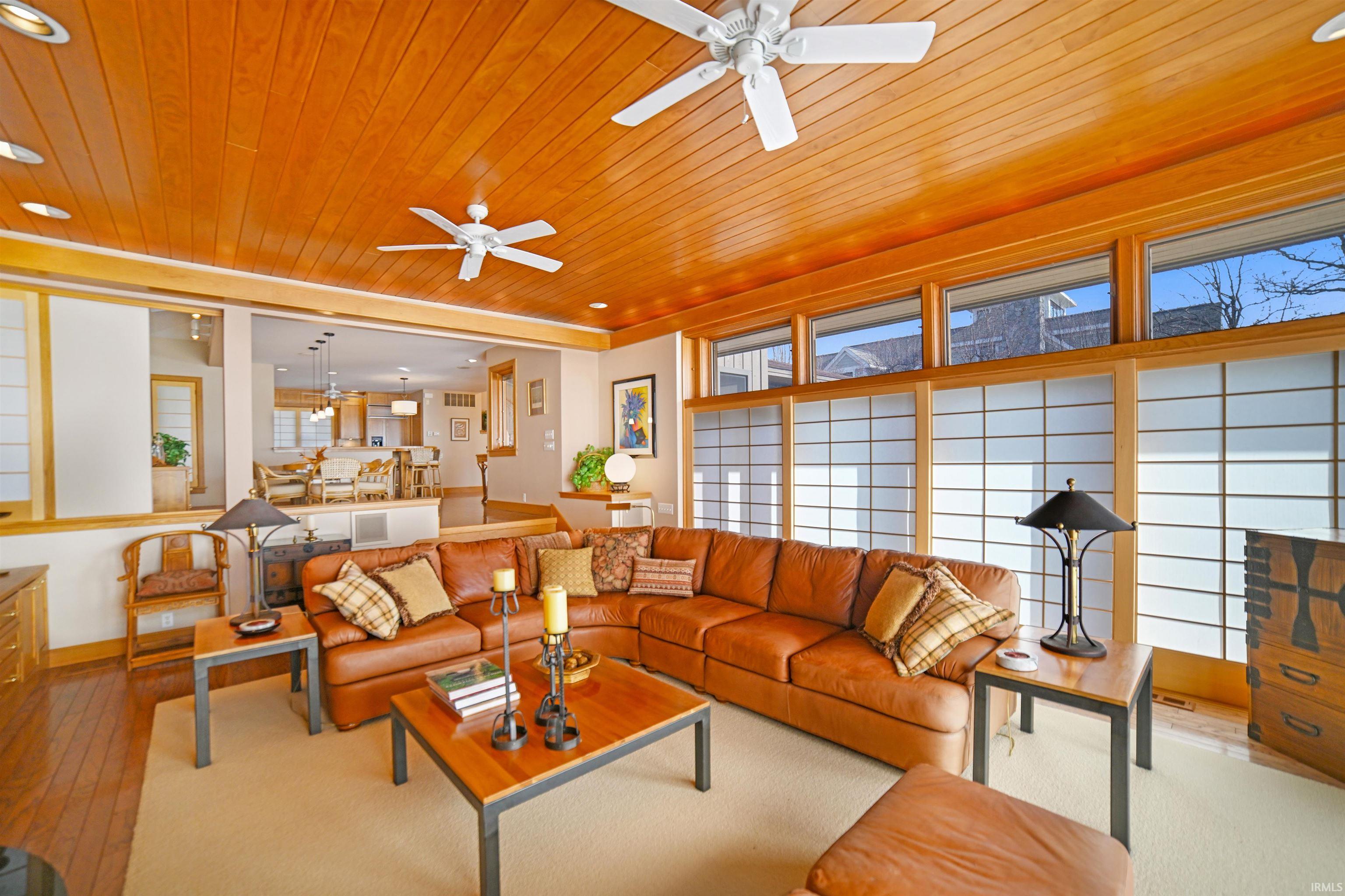 Living room featuring wooden ceiling, hardwood / wood-style flooring, ceiling fan, and recessed lighting