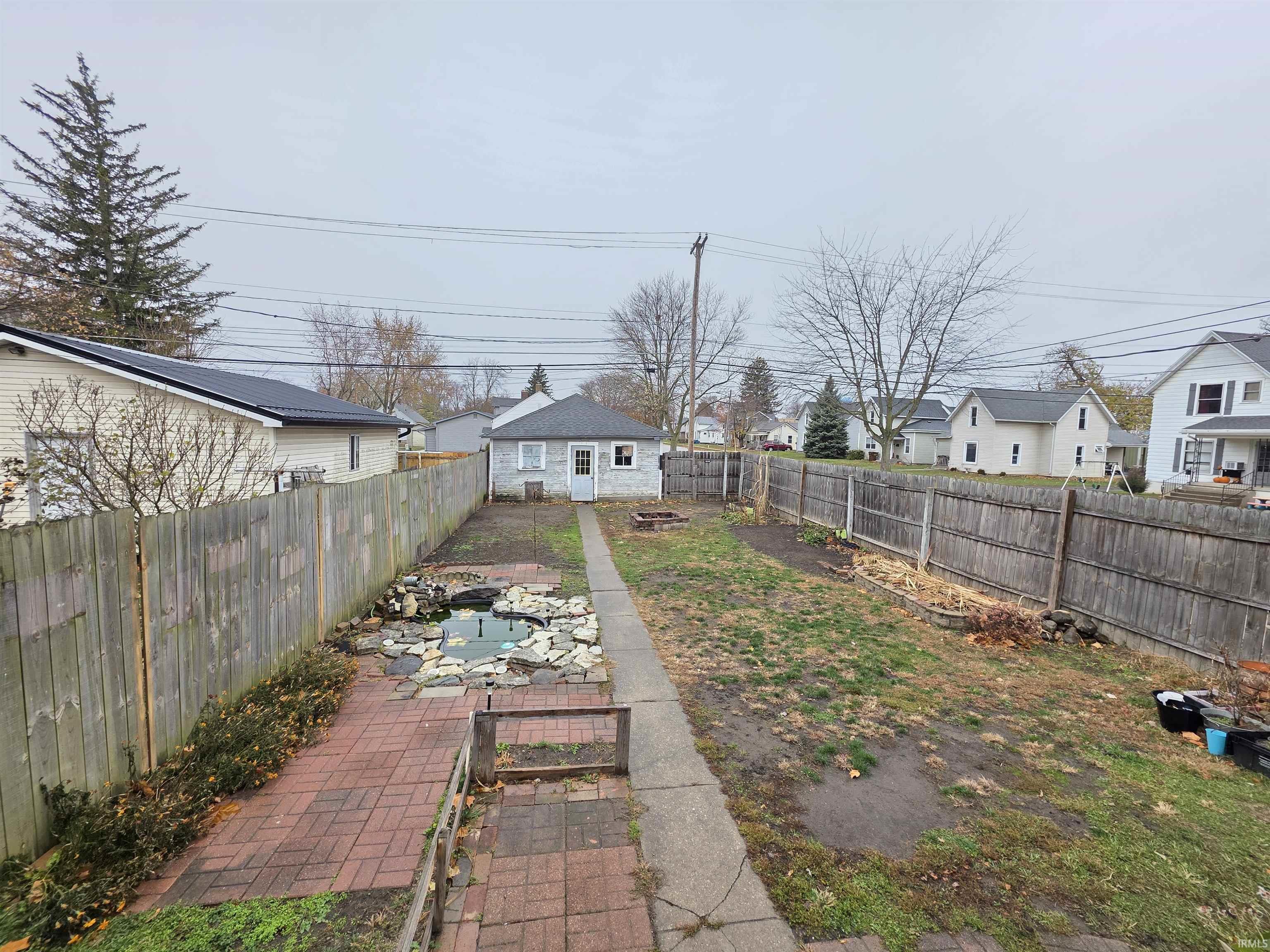 Fenced backyard featuring a residential view and a patio
