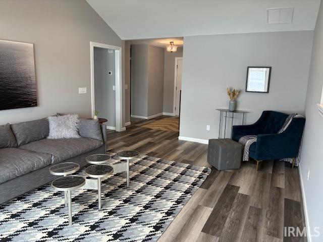 Living area with wood finished floors and lofted ceiling
