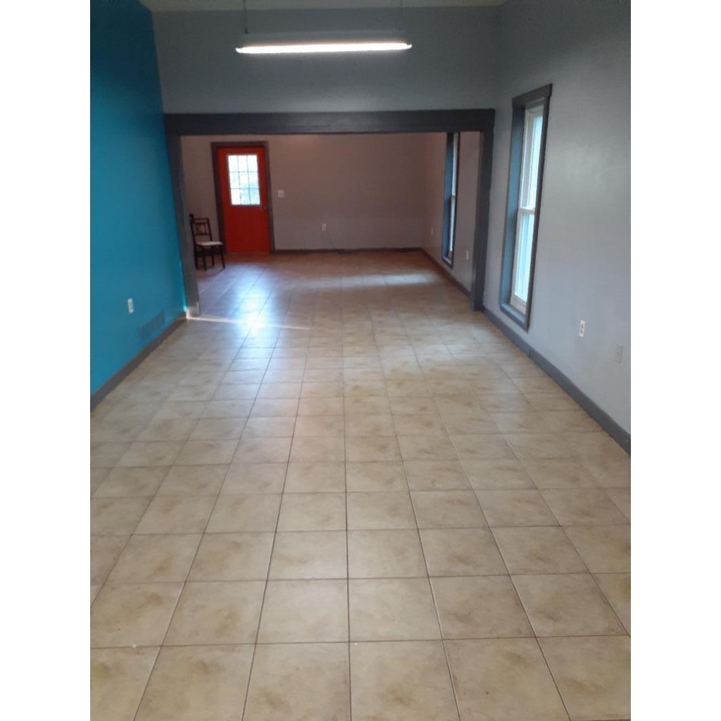 Spare room featuring baseboards and light tile patterned flooring