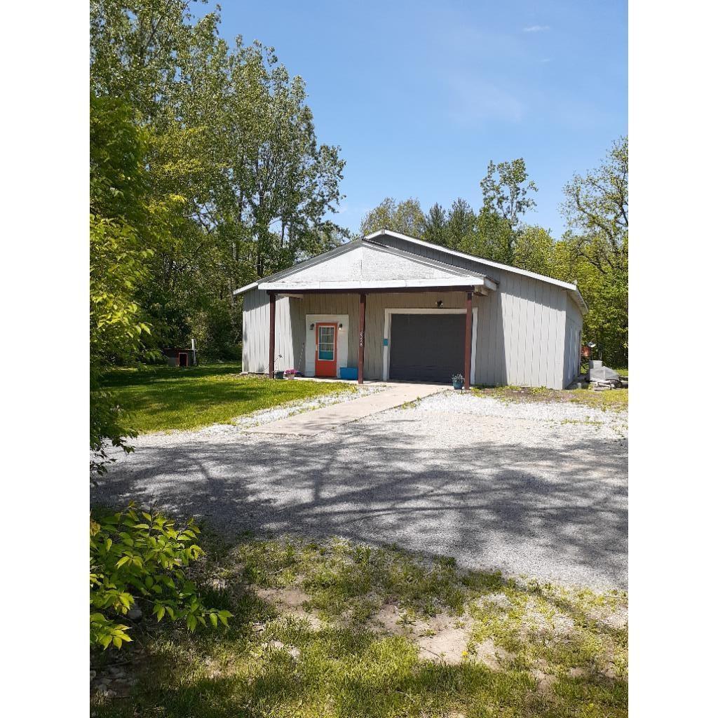 Garage featuring gravel driveway